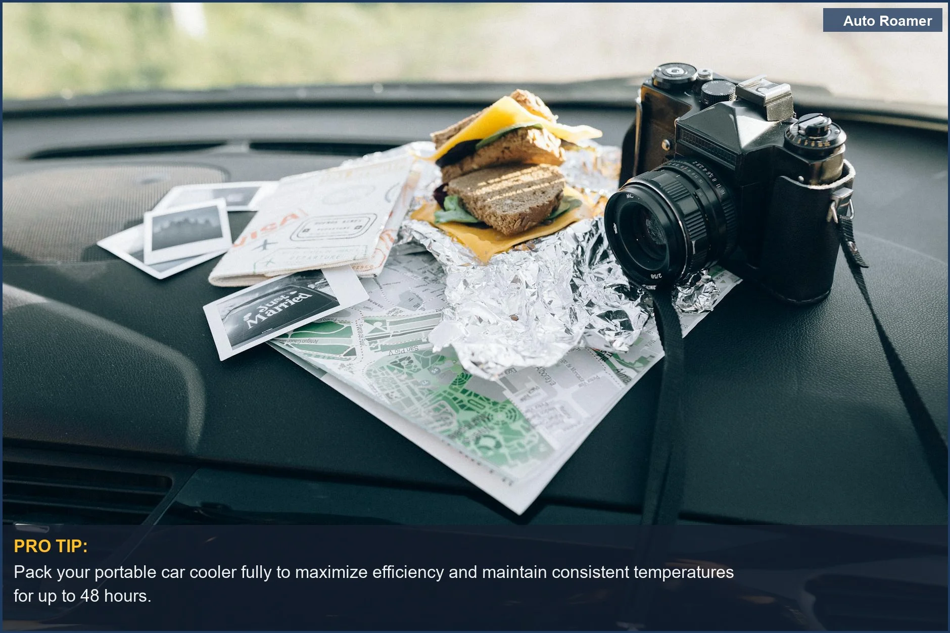 Preparing for a road trip with a portable car cooler, camera, and map on the dashboard.