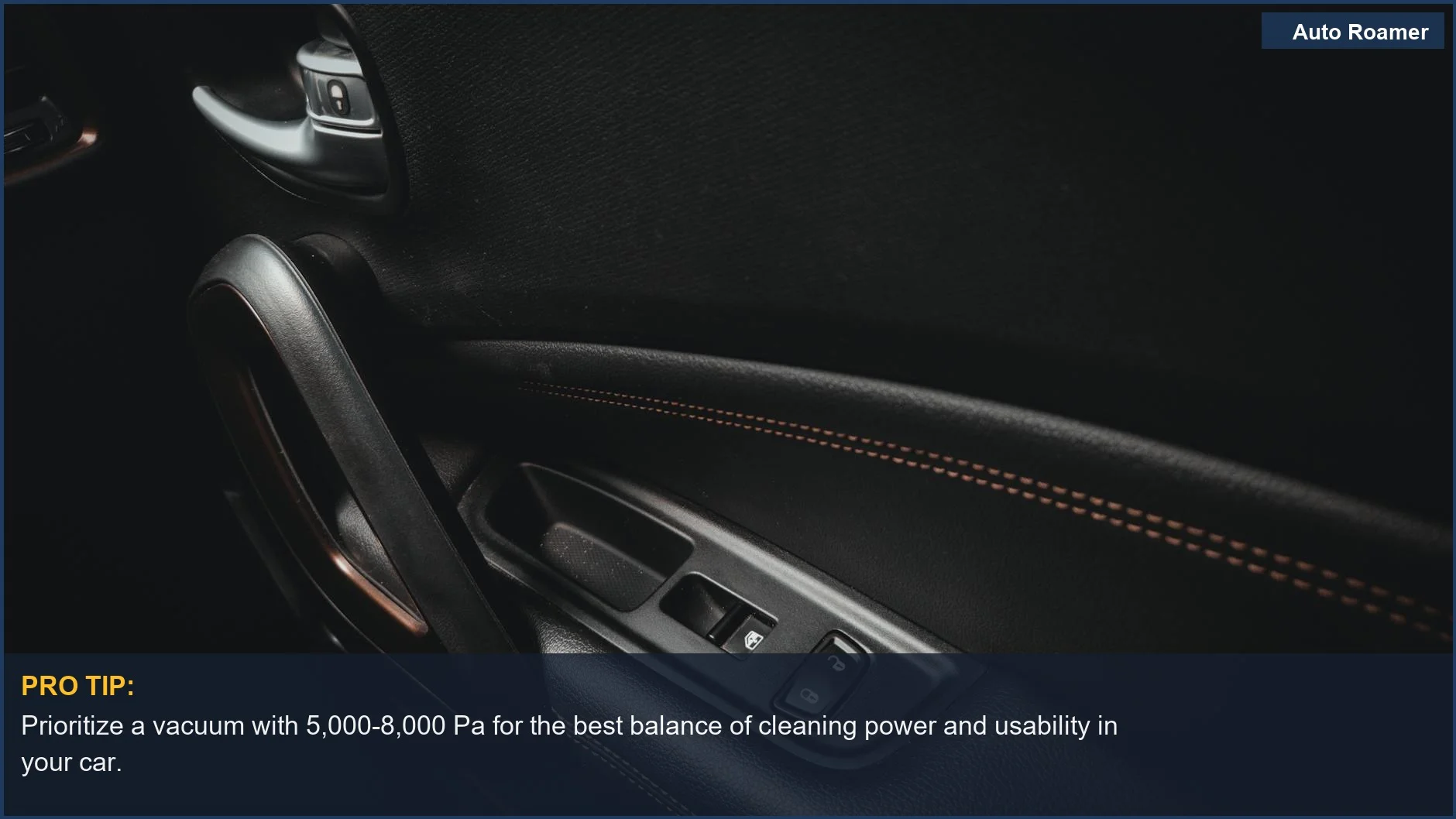 Detailed view of a car door interior with handle and stitching, showcasing the necessity of adequate car vacuum suction power.