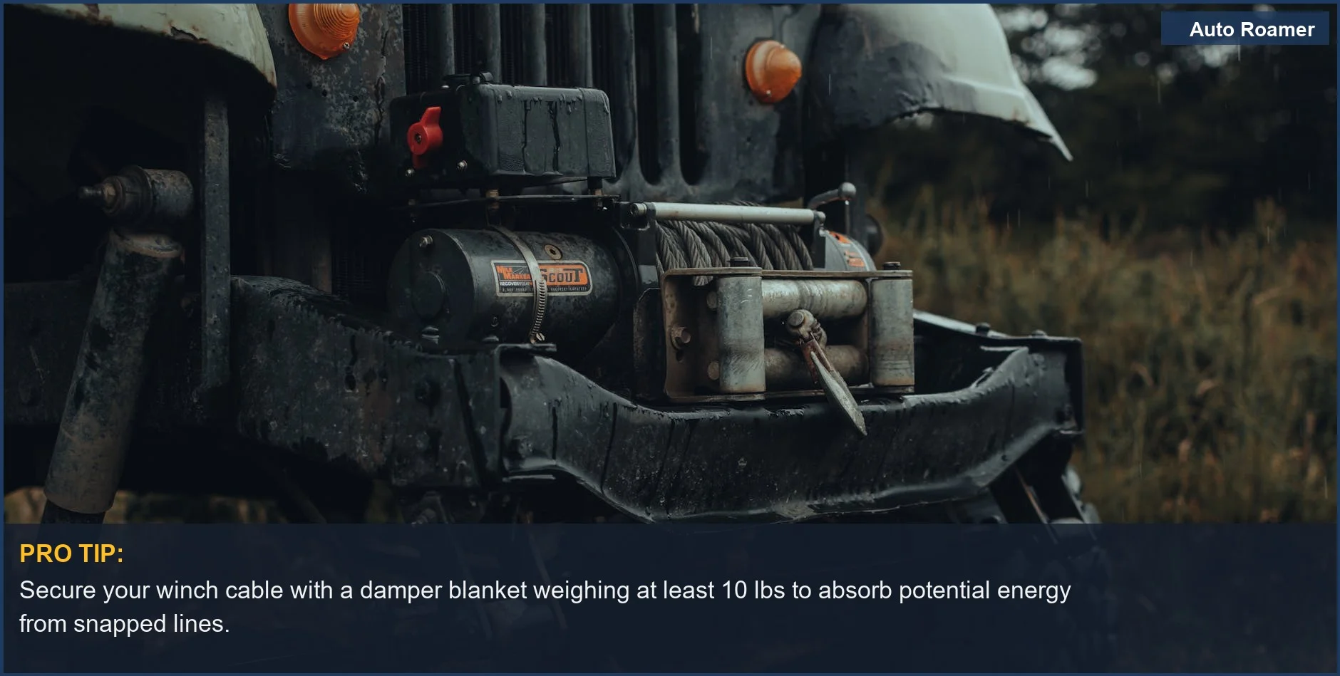 Close-up of an off-road vehicle bumper with a metal tow winch, showcasing essential winch safety equipment.