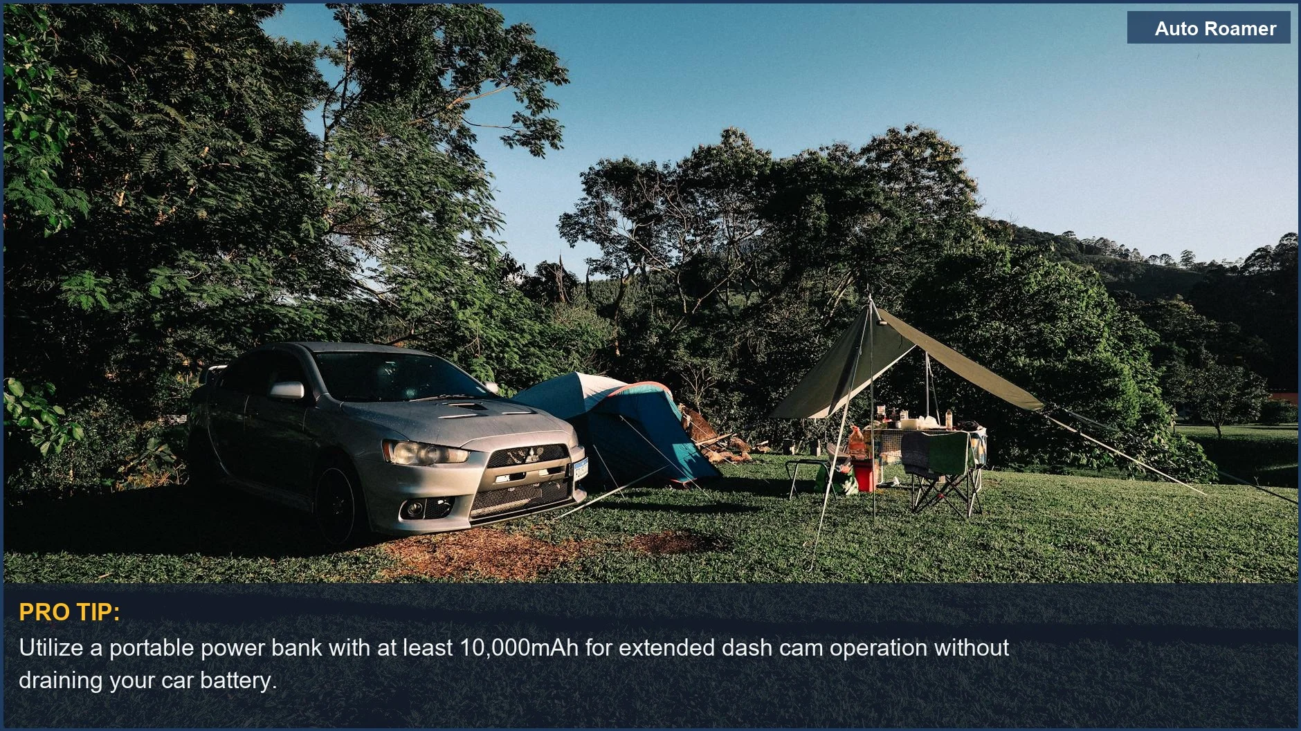 Parked Kia Soul and tent in a lush green camping spot for continuous dash cam power.