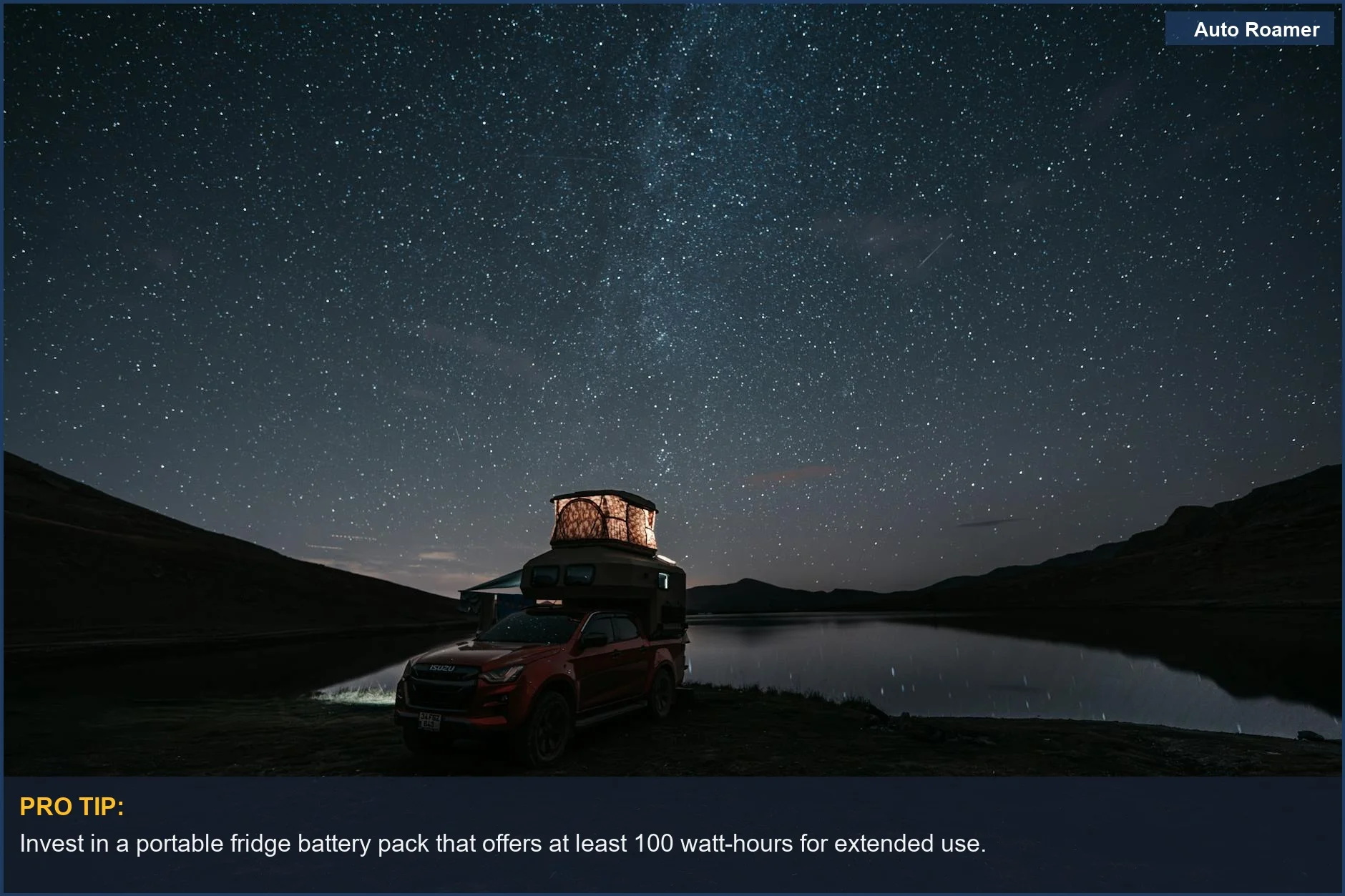 Serene lakeside camping with pickup truck under starry sky, showing portable fridge battery solutions.