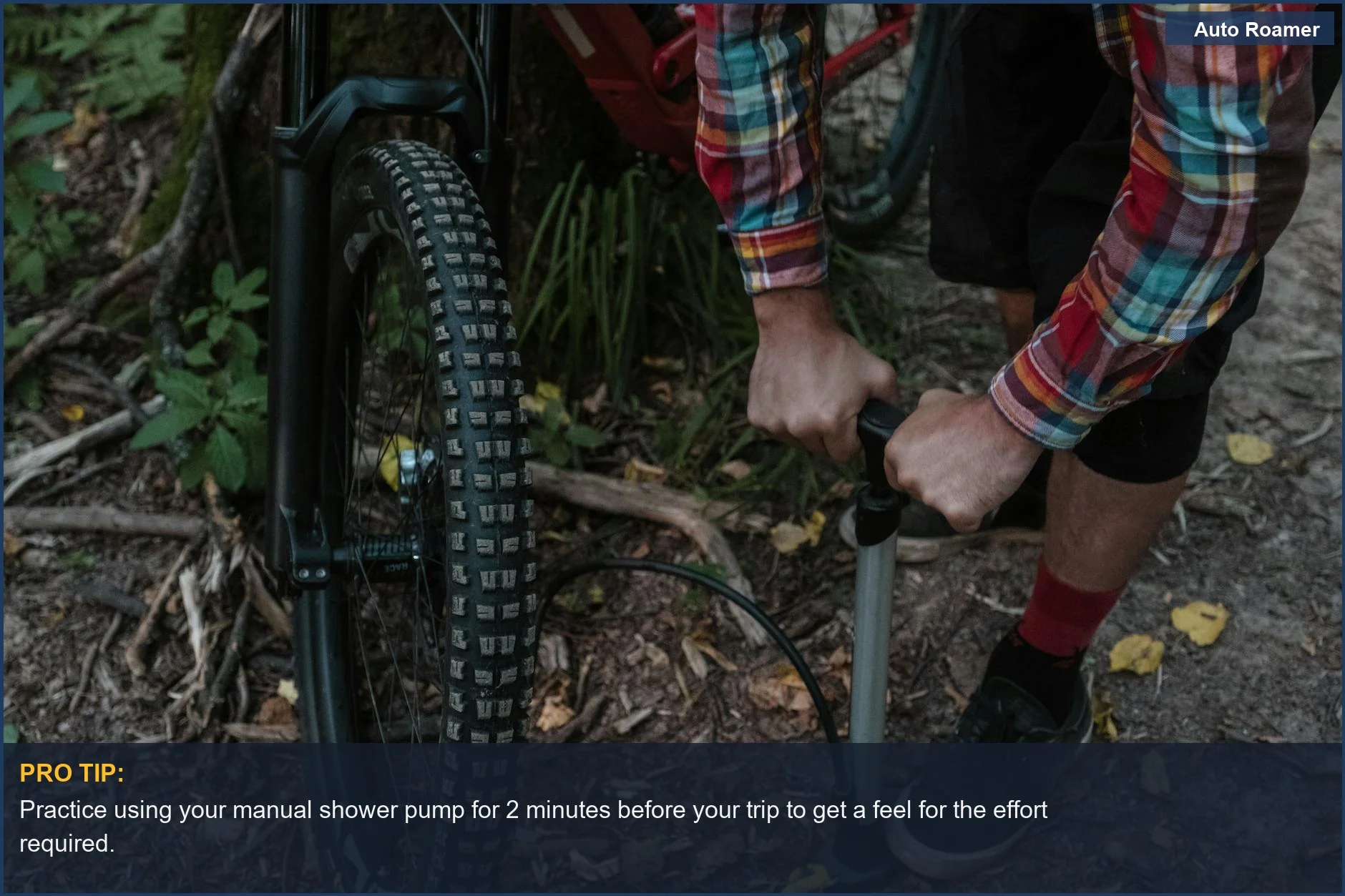 Cyclist inflating a tire with a hand pump in a forest, highlighting manual portable shower power.