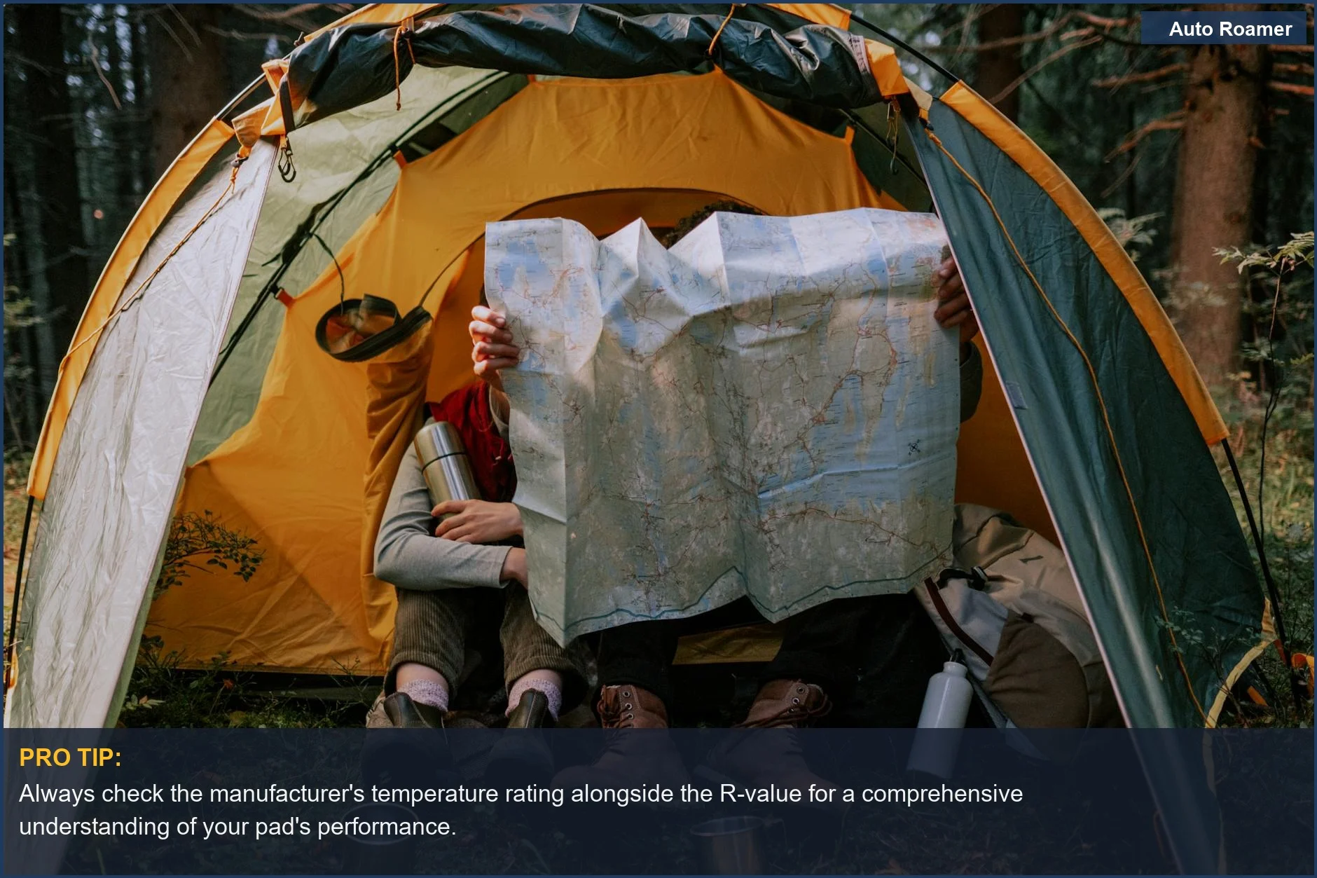 Campers examining map inside tent, demonstrating the importance of R-value for temperature rating.