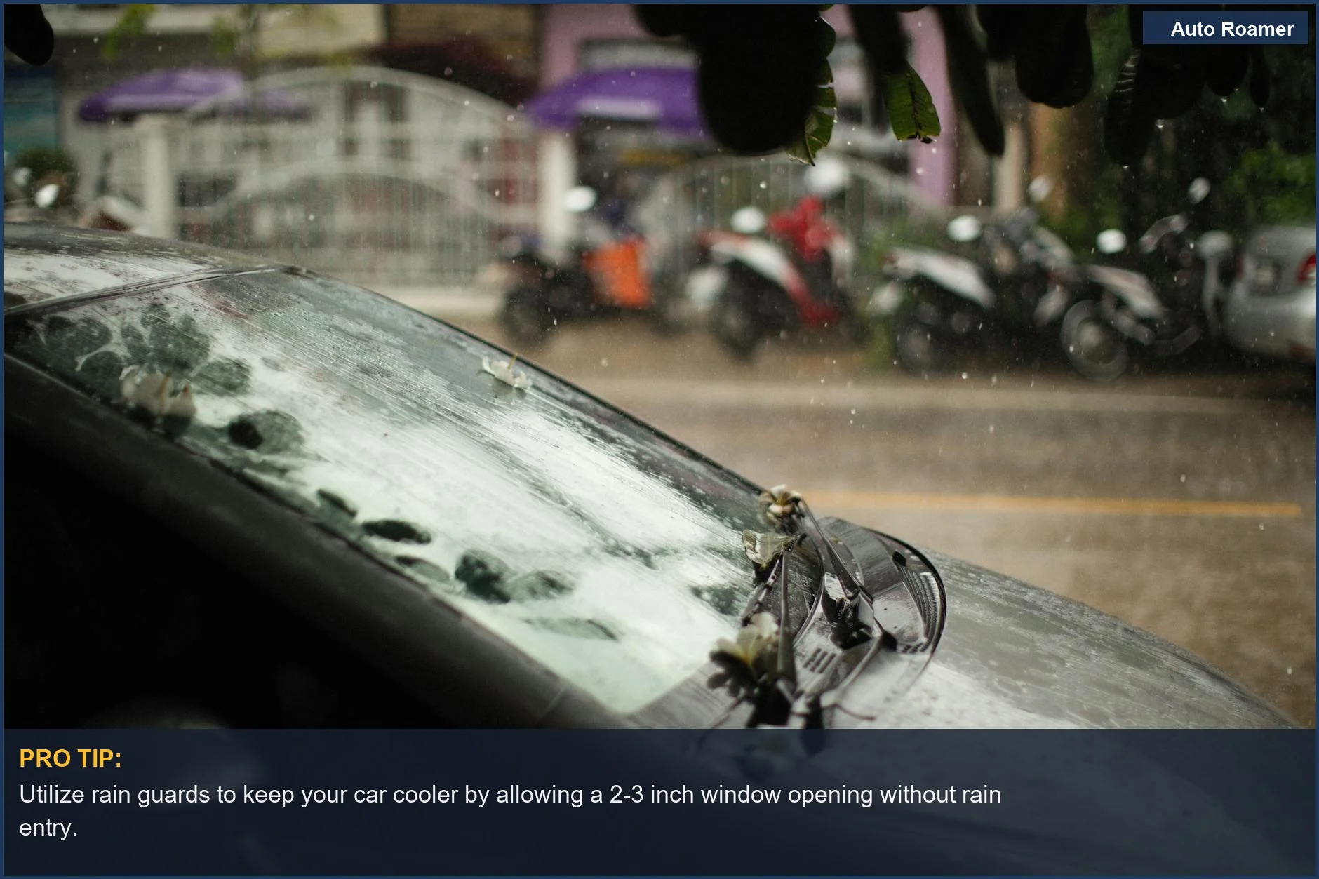 Black car windshield with raindrops, showcasing how window visors ventilation can help during rainy car camping.