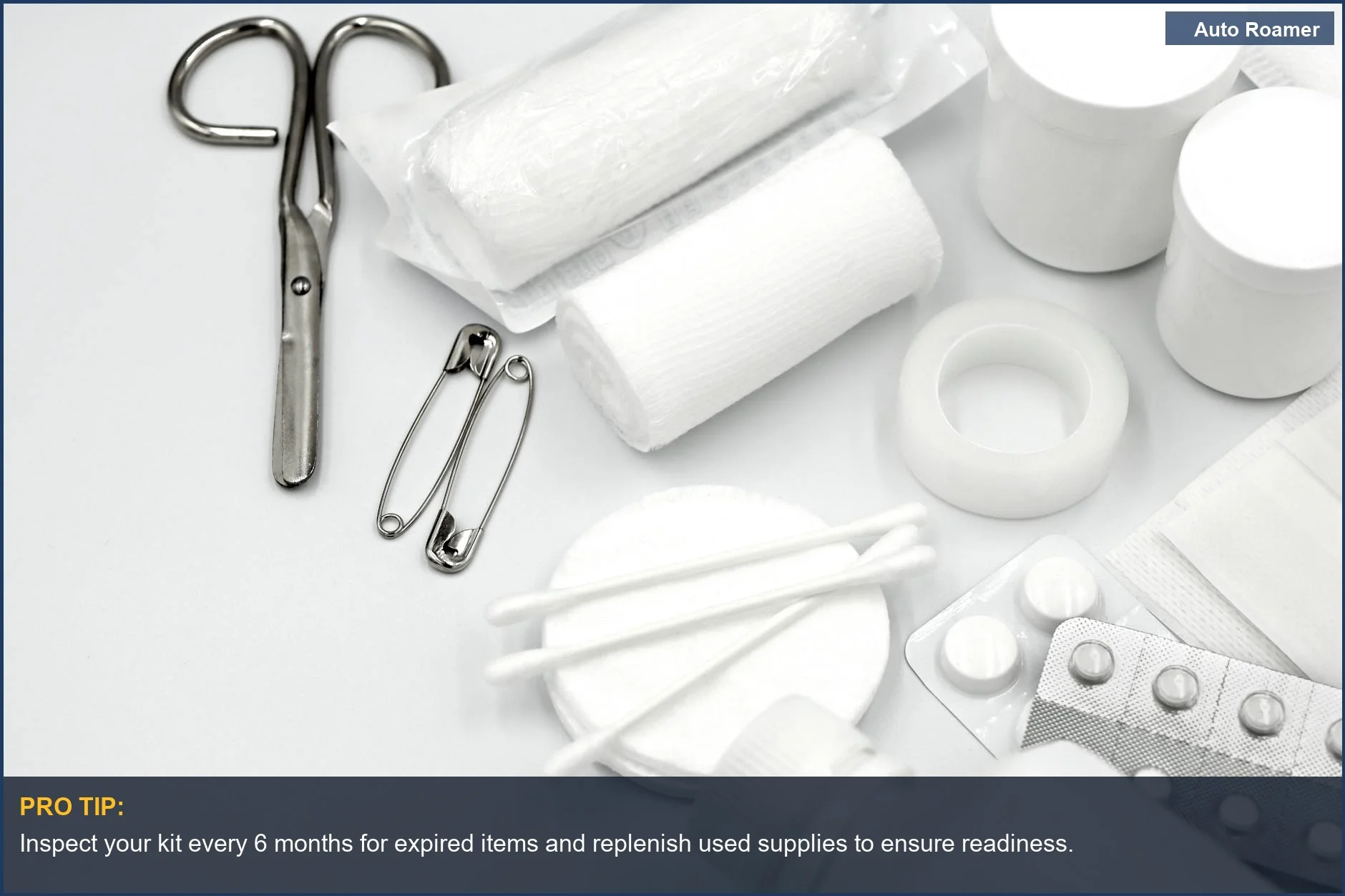 Flat lay of camping first aid kit essentials, including bandages, scissors, and medication for restocking.