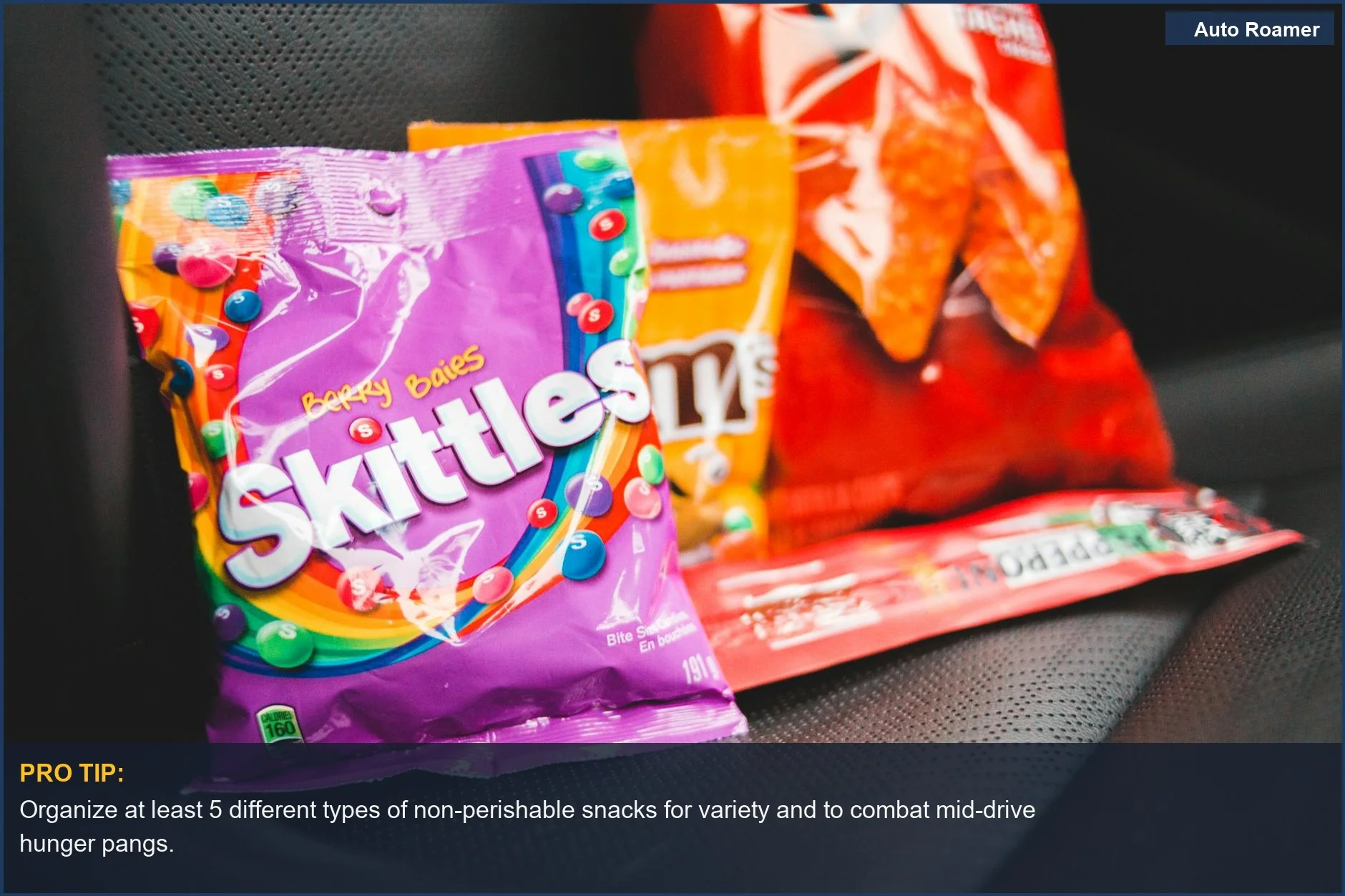 Assortment of multicolored snack packages neatly arranged on a car seat.