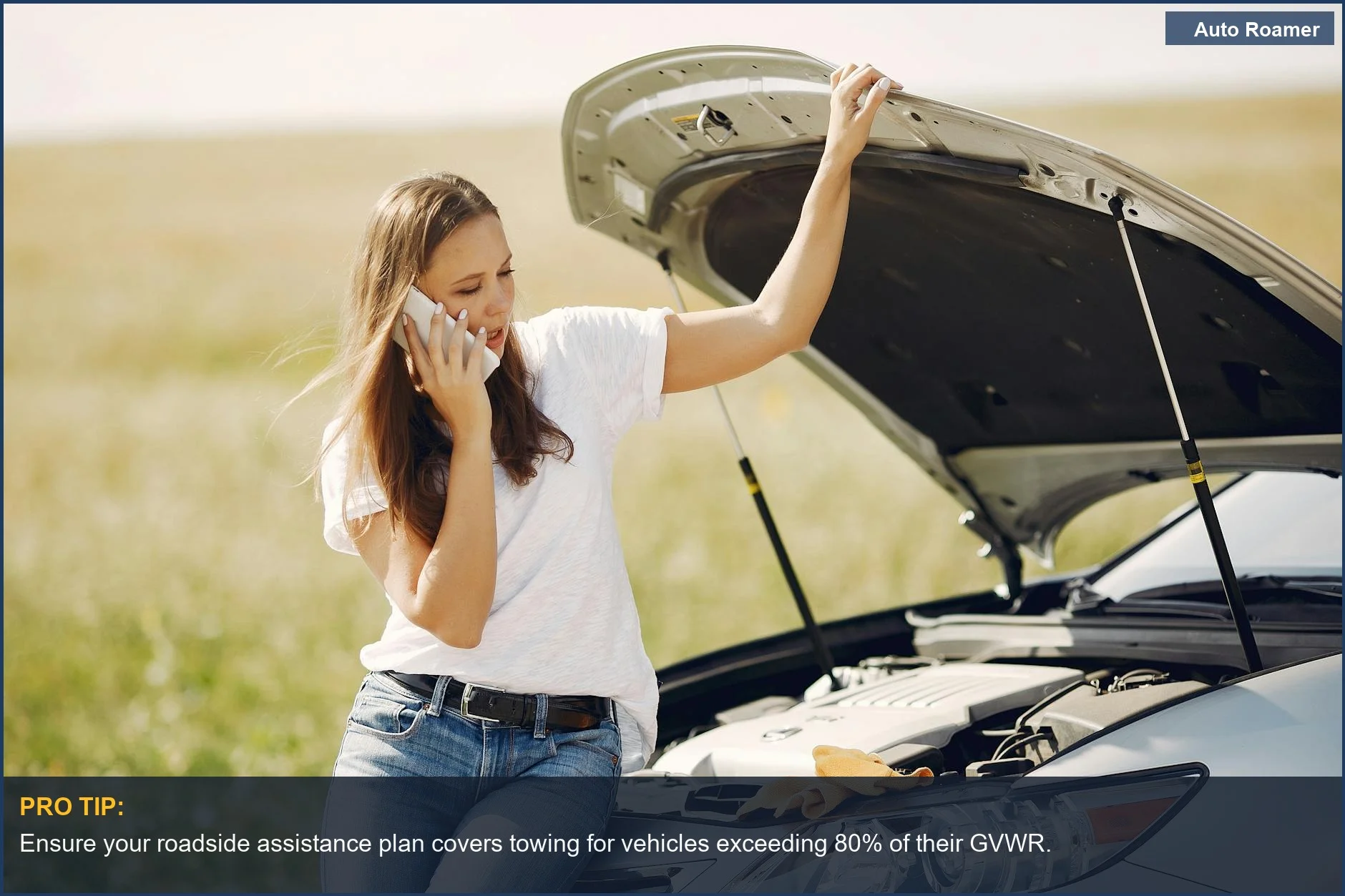 Young woman seeking help for car breakdown, highlighting roadside assistance for heavily loaded road trip cars.