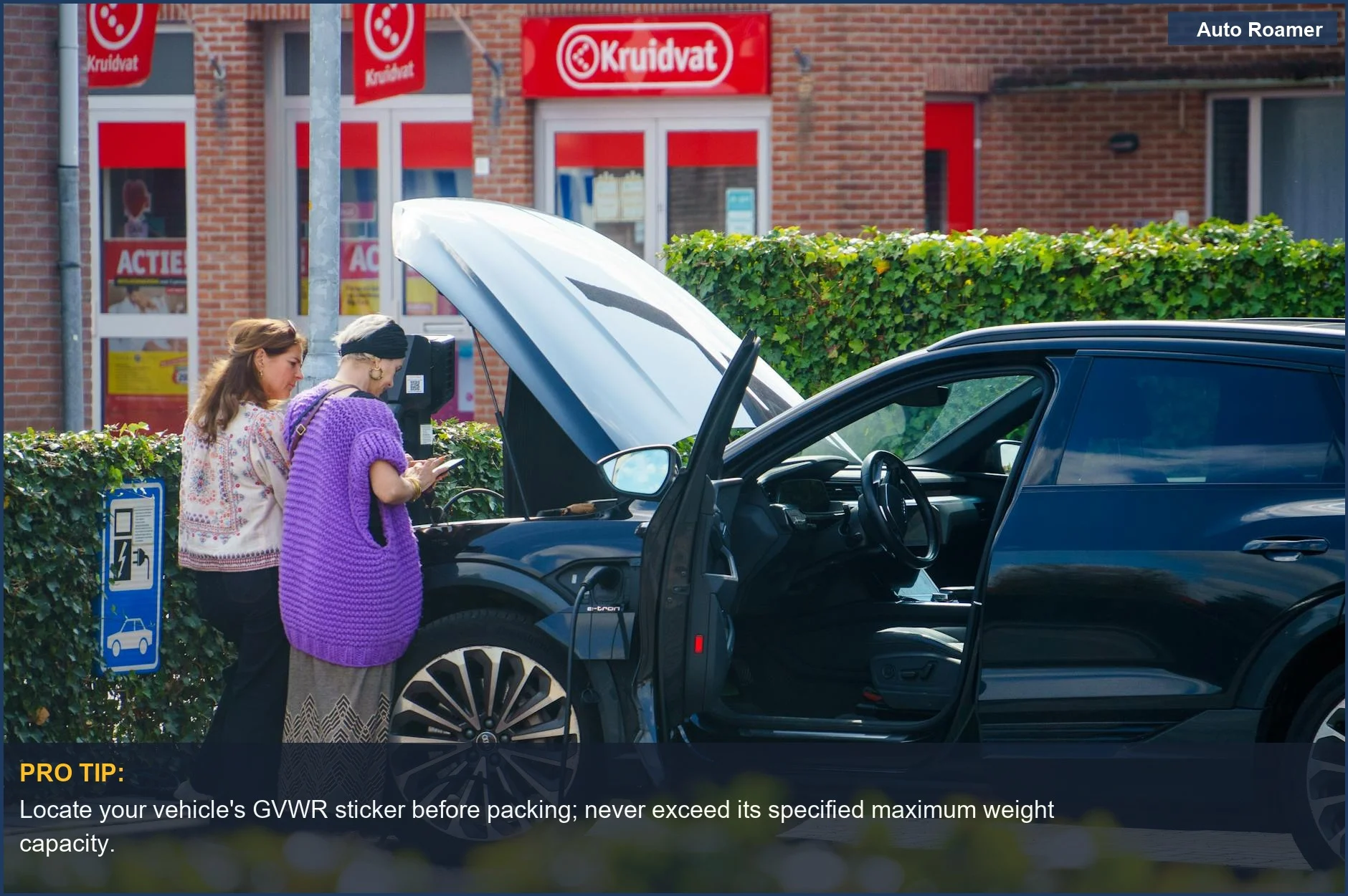Two women check an open car hood, symbolizing the need for roadside assistance for overloaded road trip vehicles.