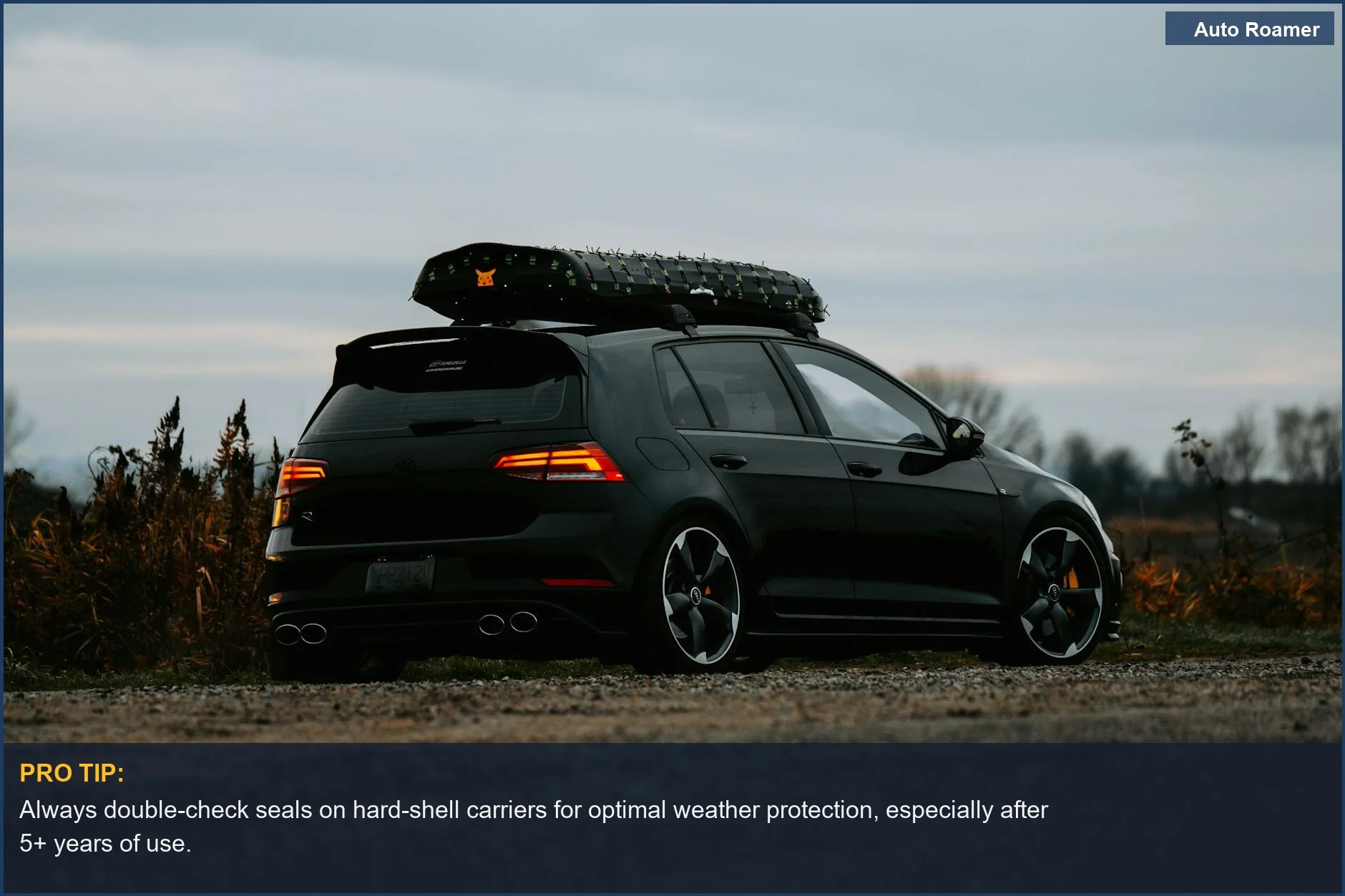 Dark hatchback with roof storage parked at twilight, showcasing weather protection for travel gear.