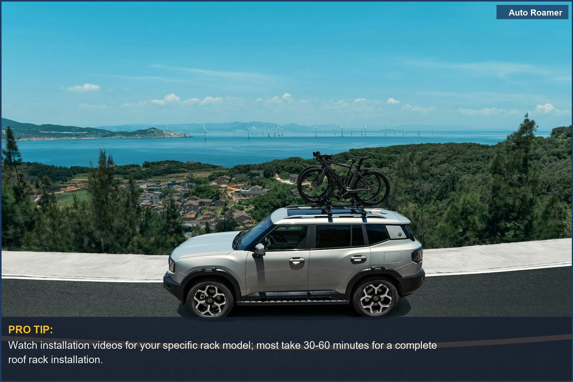 Silver SUV with bicycles on a roof rack drives along a scenic coastal road, showcasing roof rack installation.