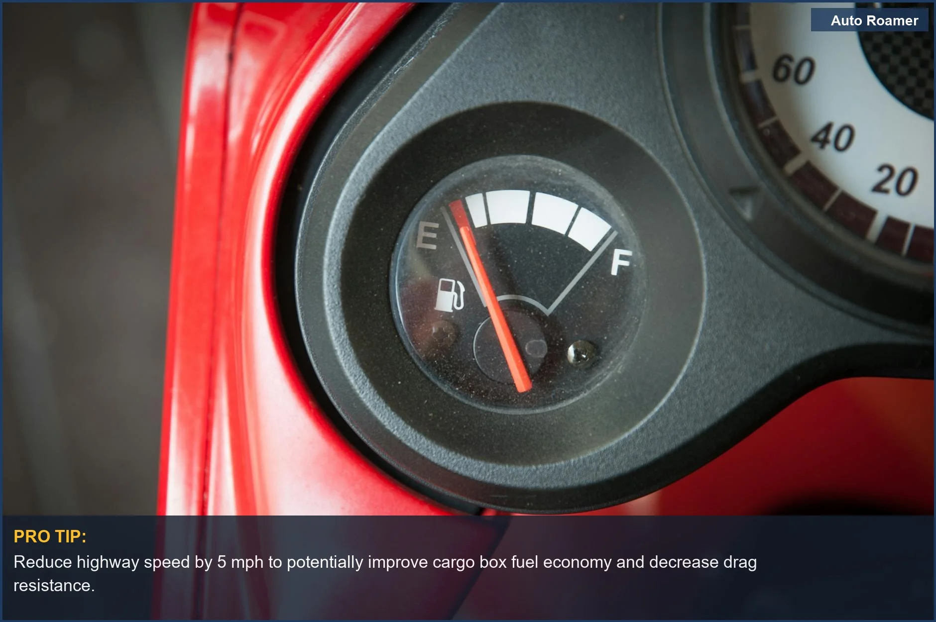Close-up of a car's fuel gauge needle pointing to empty, highlighting the fuel economy cost of rooftop cargo boxes.