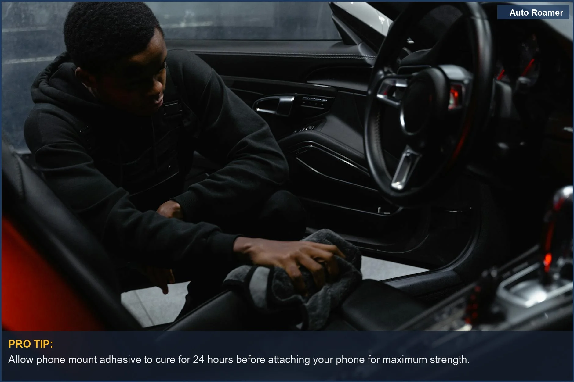 Man wiping car interior for detailing and maintenance before installing phone mount.