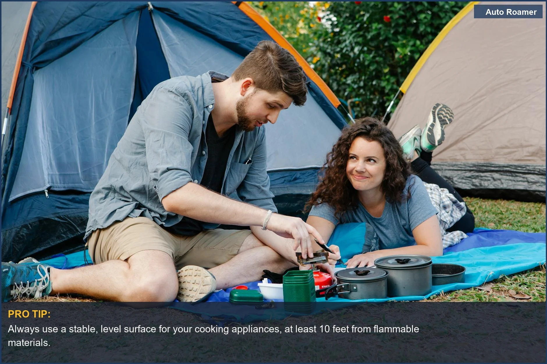 Couple uses portable camping stove safely, illustrating campsite safety for electric appliances.