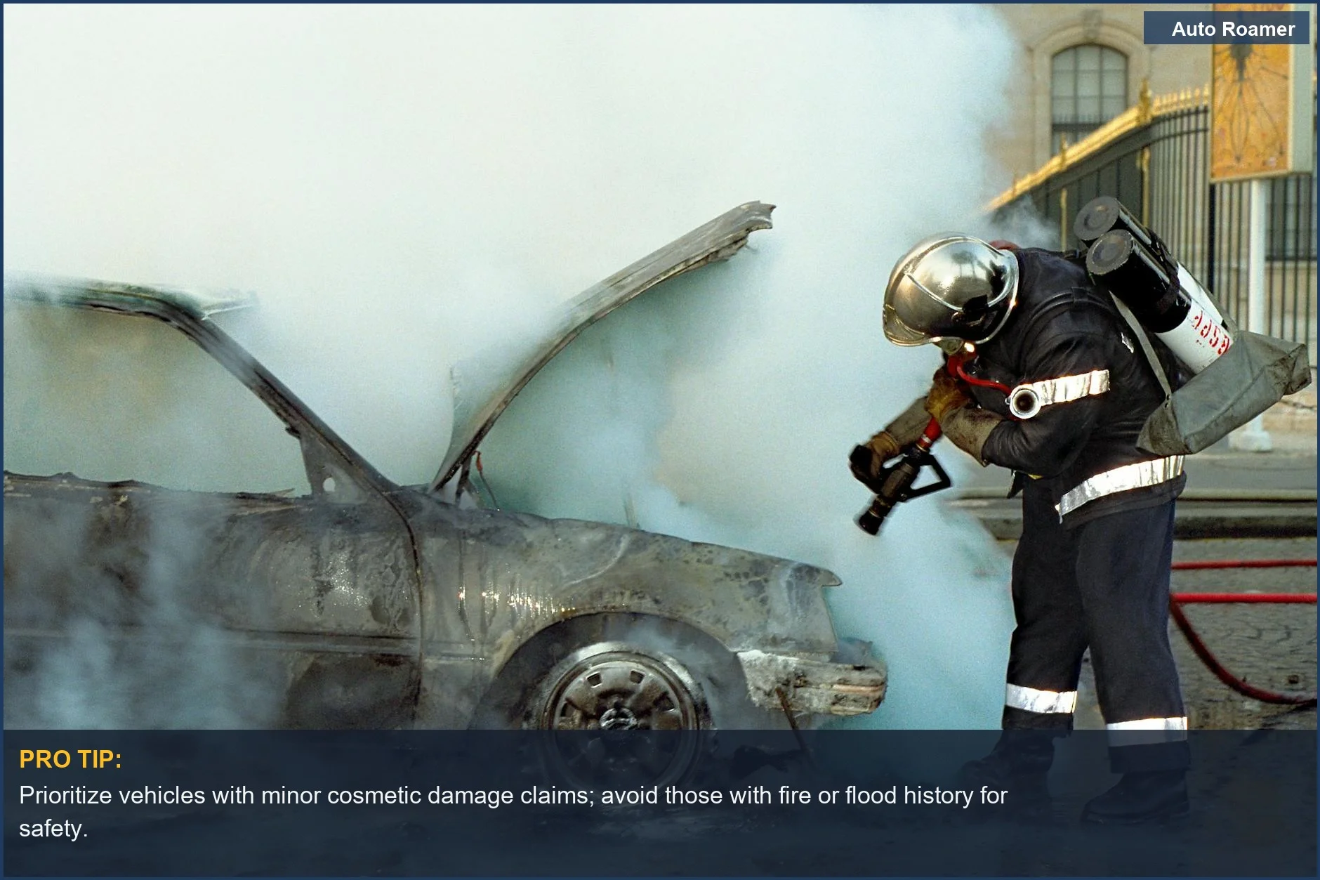 Firefighter extinguishing smoking damaged car, a high-action scene of potential salvage title car camping vehicle risks.