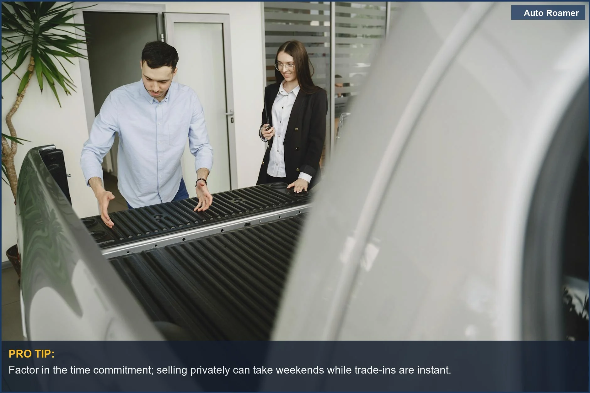 Salesman and client inspect a pickup truck, discussing features, illustrating the negotiation process in a car trade-in.