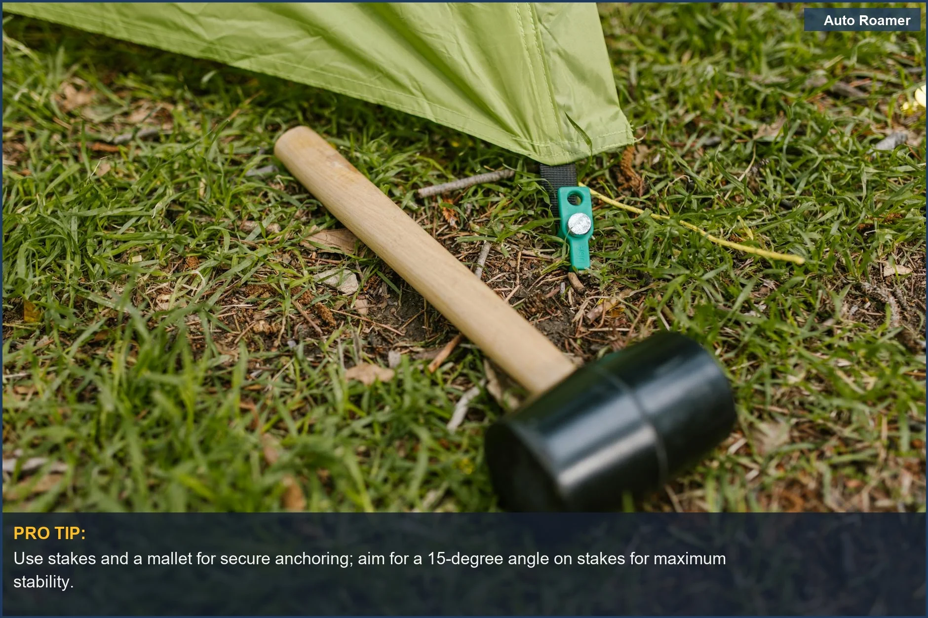 Rubber mallet next to a green tent pegged on grass, highlighting quick shower tent assembly.