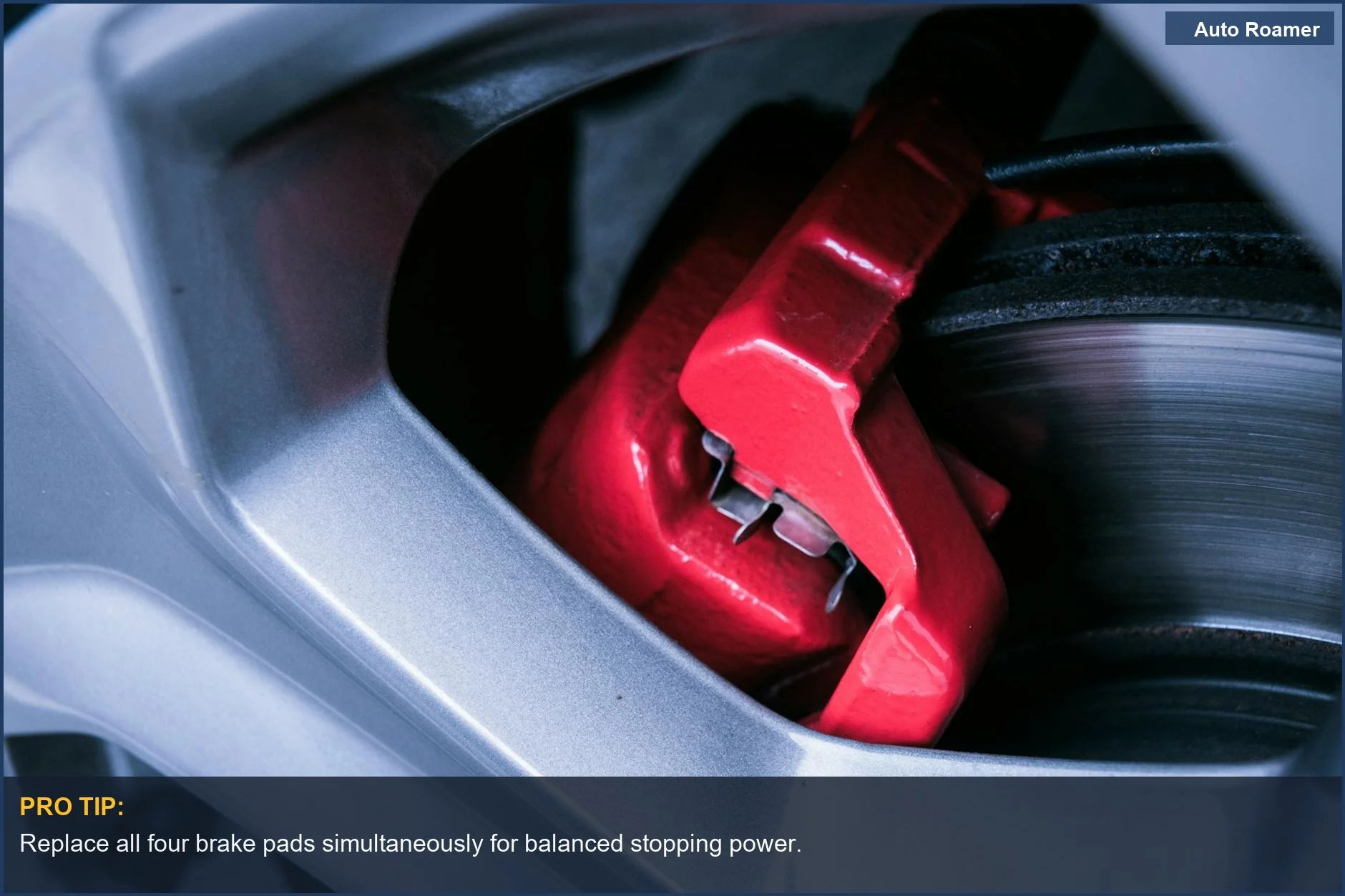 Close-up of a red automotive brake caliper and disc, a key component in stopping.