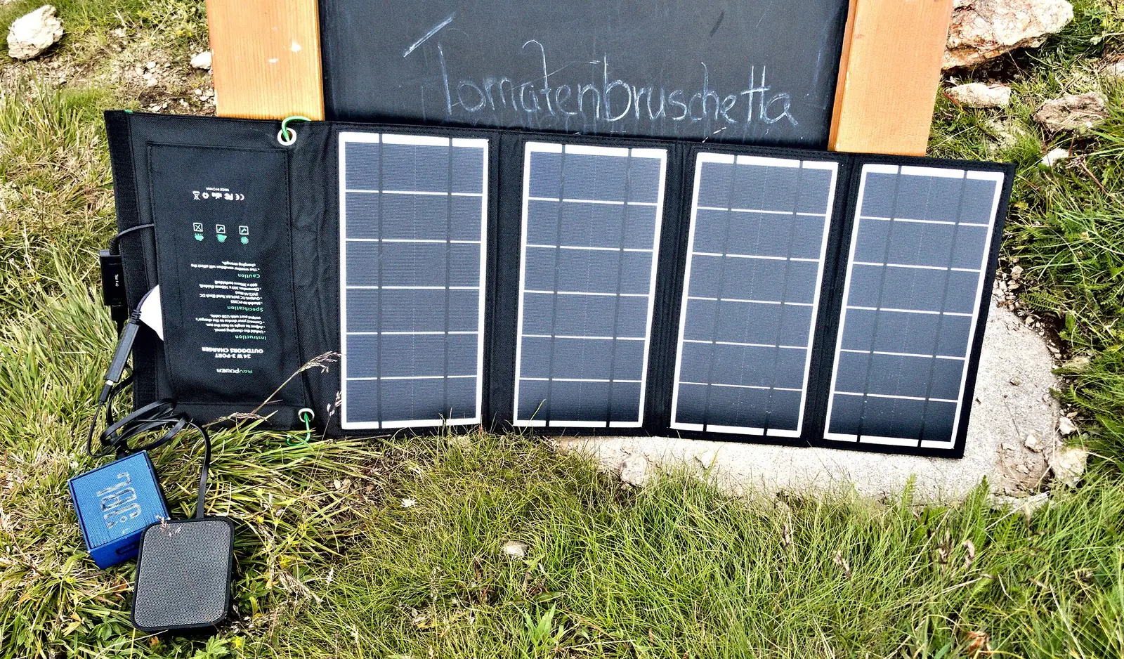A portable folding solar panel unfolded on the grass, the kind that feeds a power station this troubleshooting guide gets charging again.