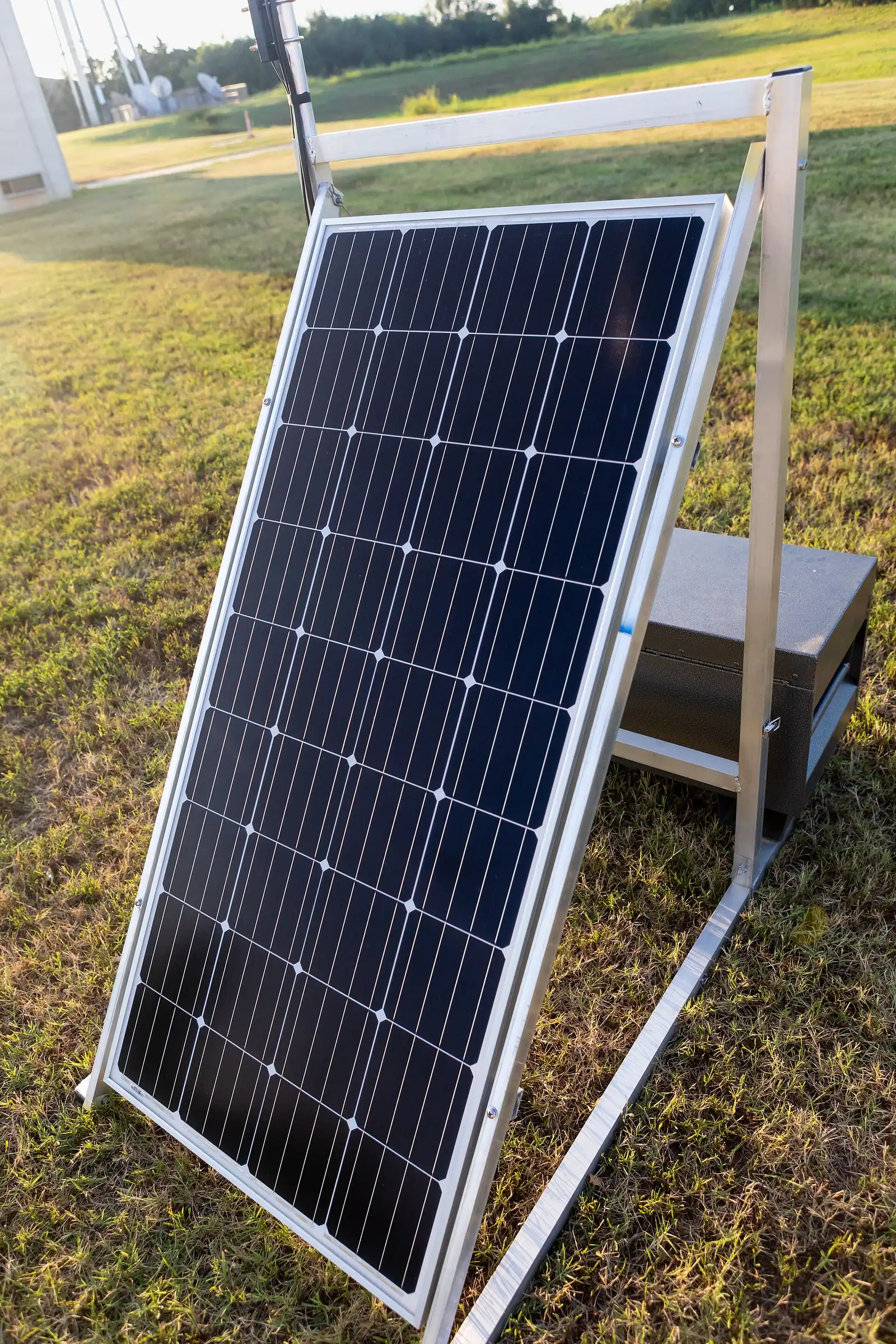 A rigid solar panel propped at an angle on a stand outdoors, the input this guide diagnoses when a power station refuses to charge.
