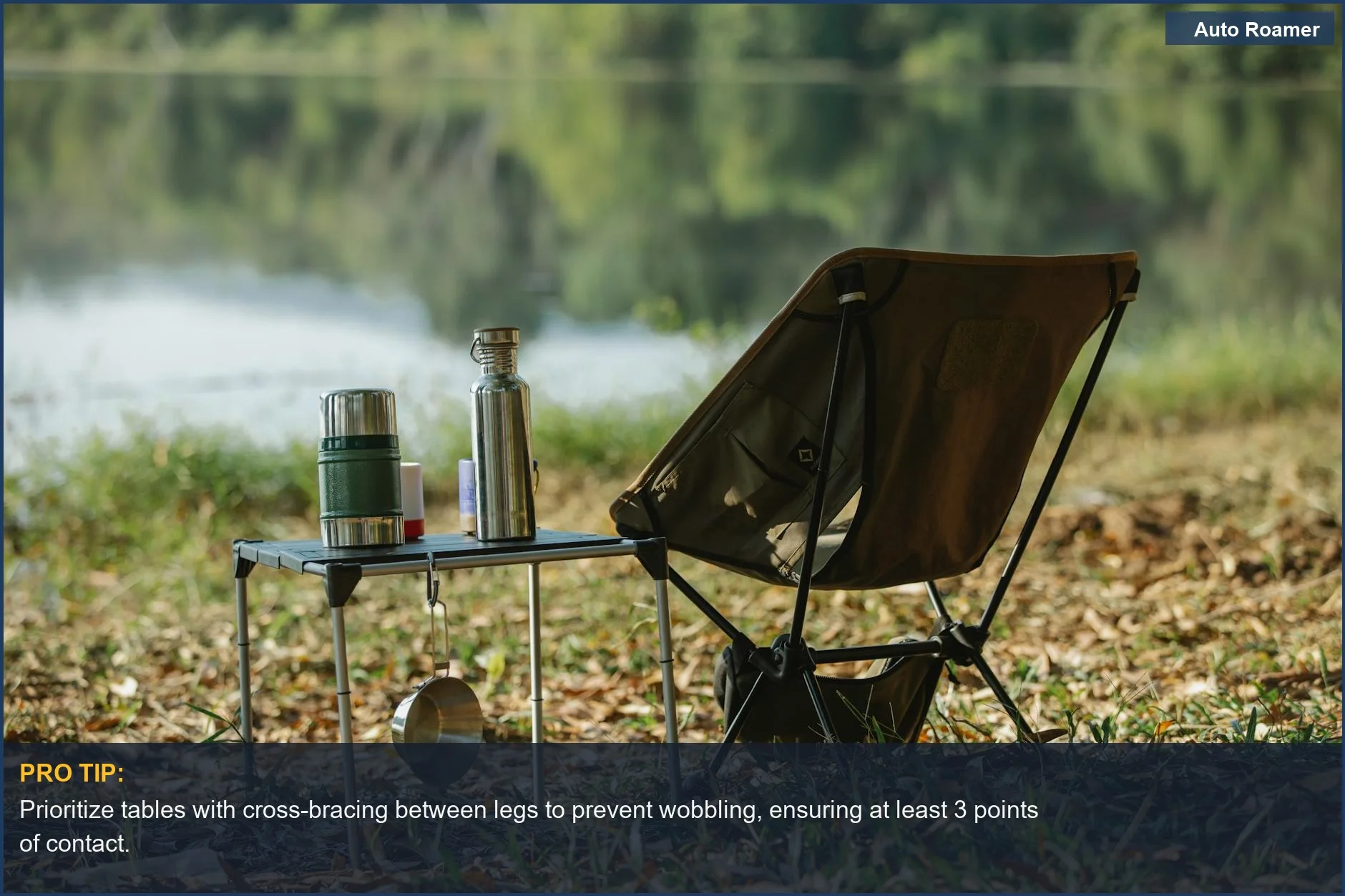 A peaceful lakeside campsite features a durable folding table with camping essentials.