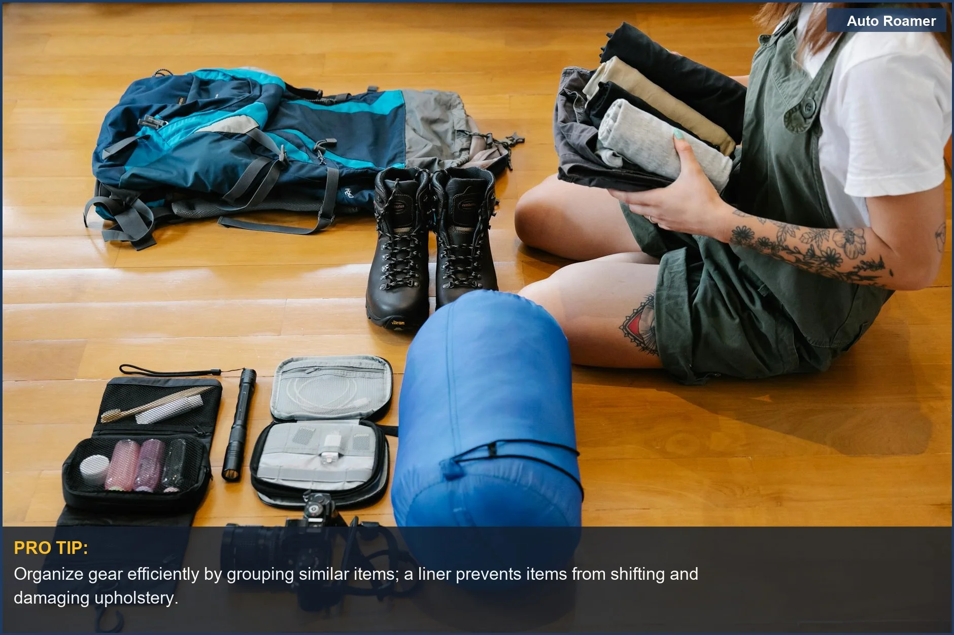 Woman organizing camping gear on a wooden floor, demonstrating the need for camping gear protection.