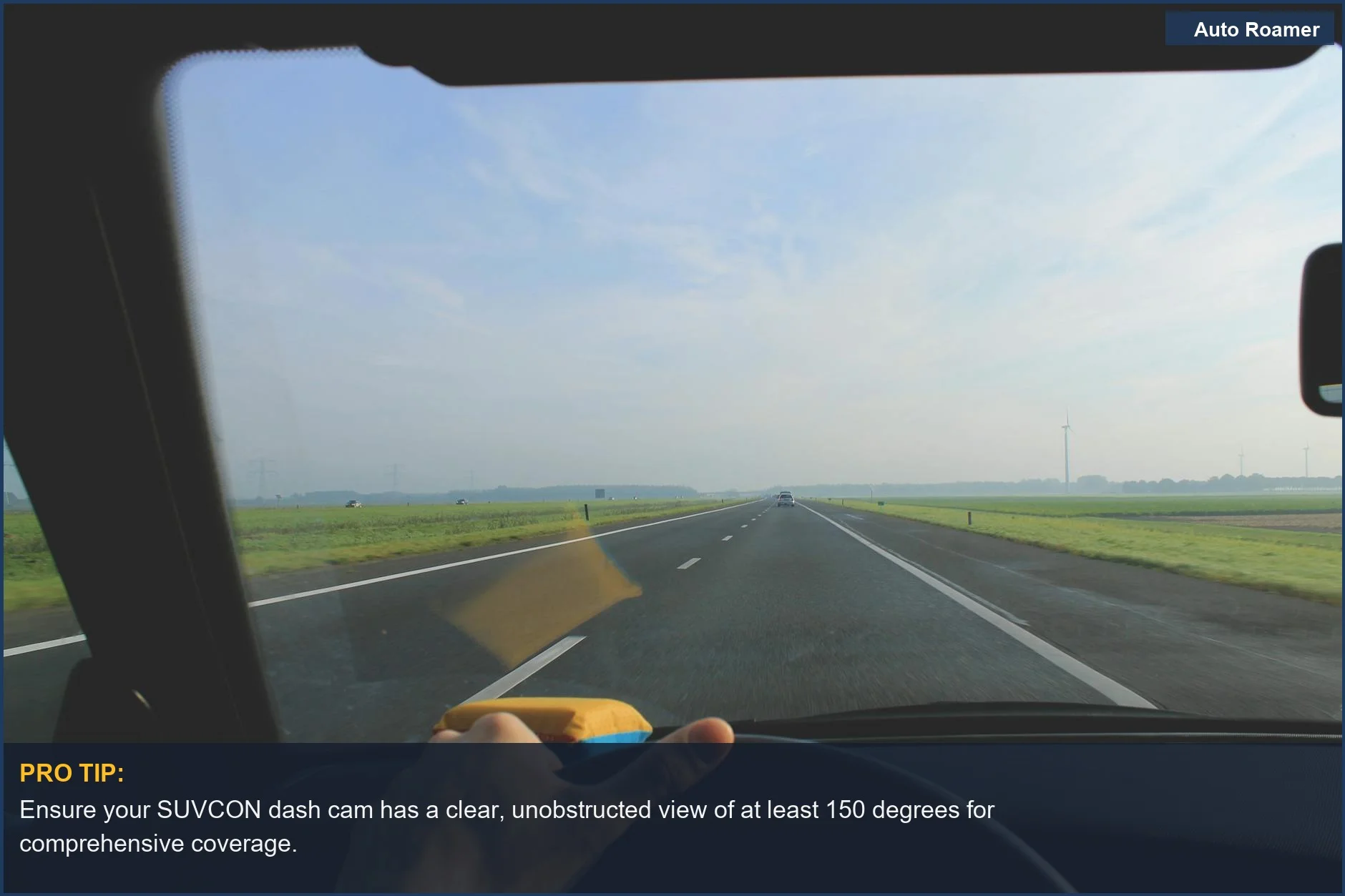 Highway driving view from SUVCON dash cam, illustrating clear skies and scenic green fields for optimal recording.