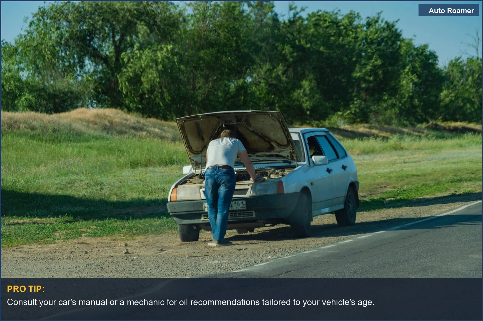 Man inspecting car breakdown on roadside, contemplating synthetic oil for older cars.