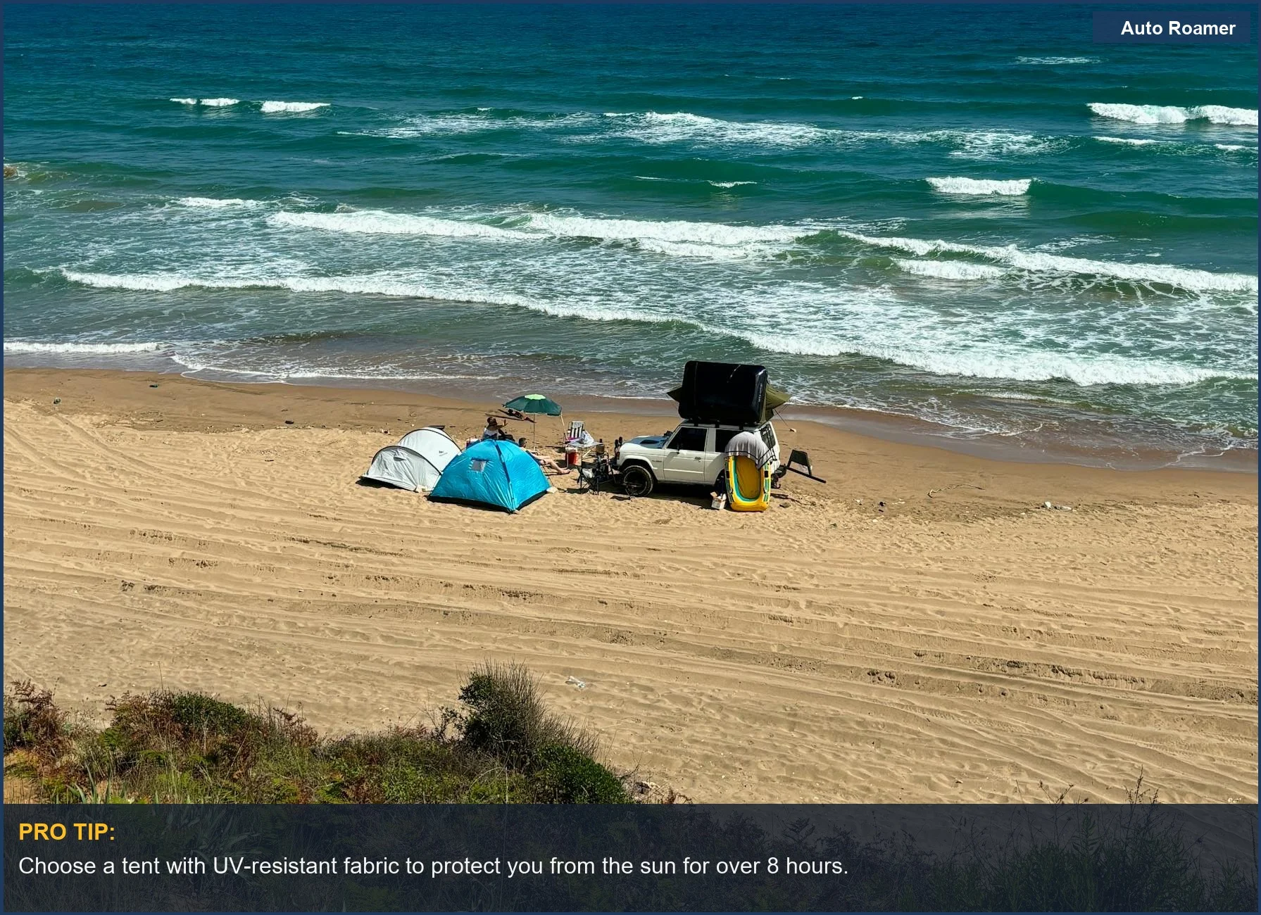 Beach camping with an SUV and tent near the ocean waves.