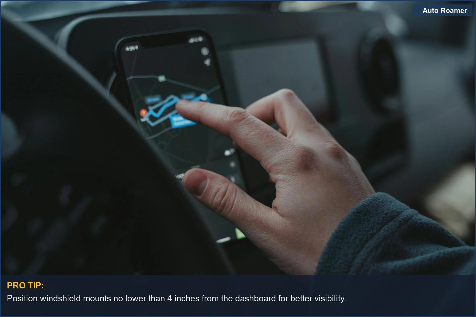 Hand using GPS navigation on a smartphone mounted to a Tesla Model 3 windshield.