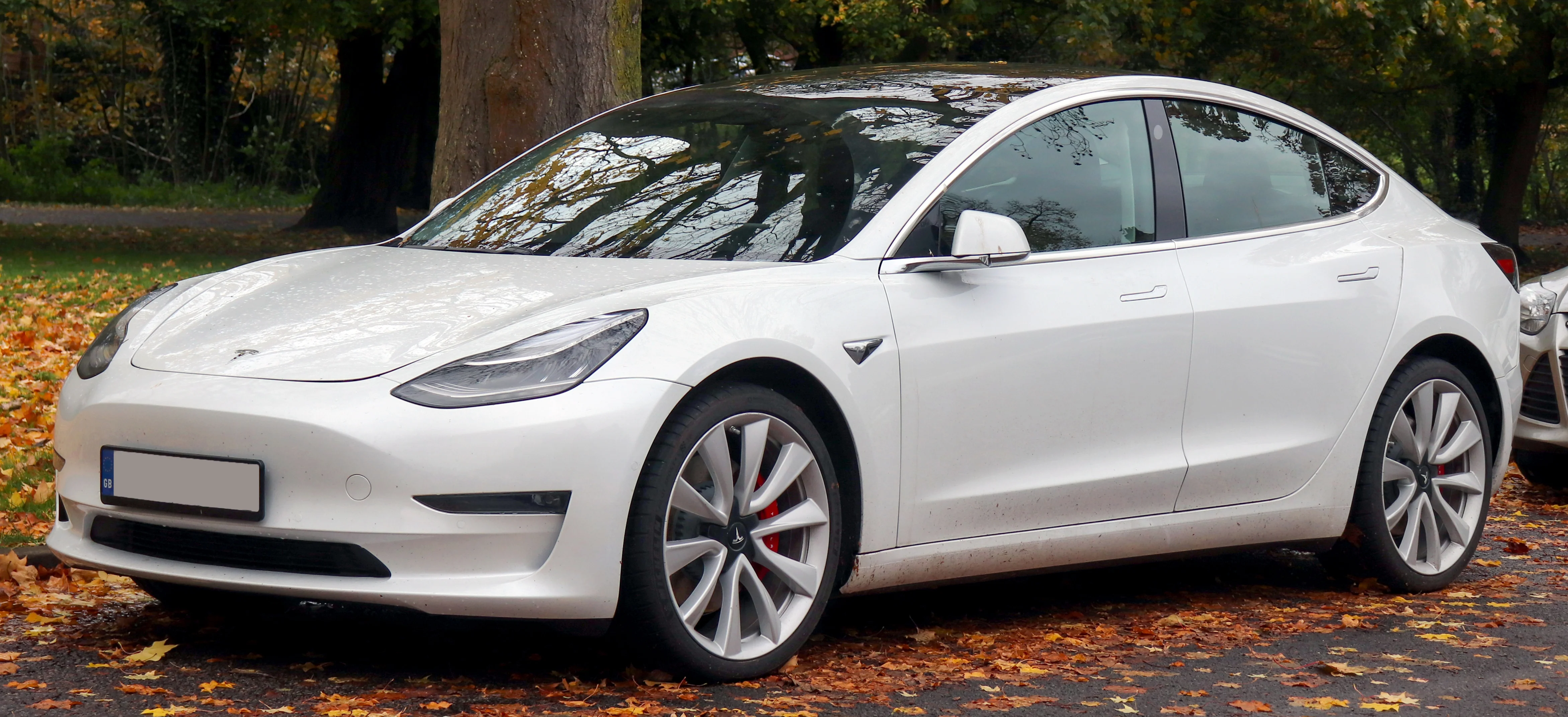 A white Tesla Model 3 sedan, the trunk-only alternative this camping comparison weighs against the Model Y.
