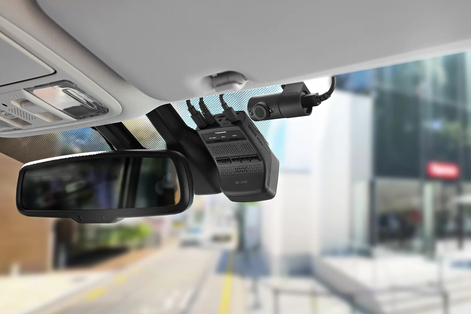 a Thinkware U3000 Pro front camera mounted in a car interior with its rear camera on the back glass