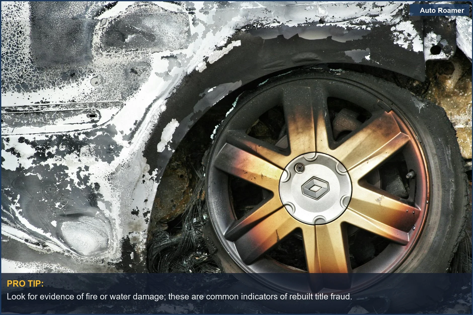 Burned car wheel with rust and damaged tire shows aftermath, hinting at rebuilt title fraud.