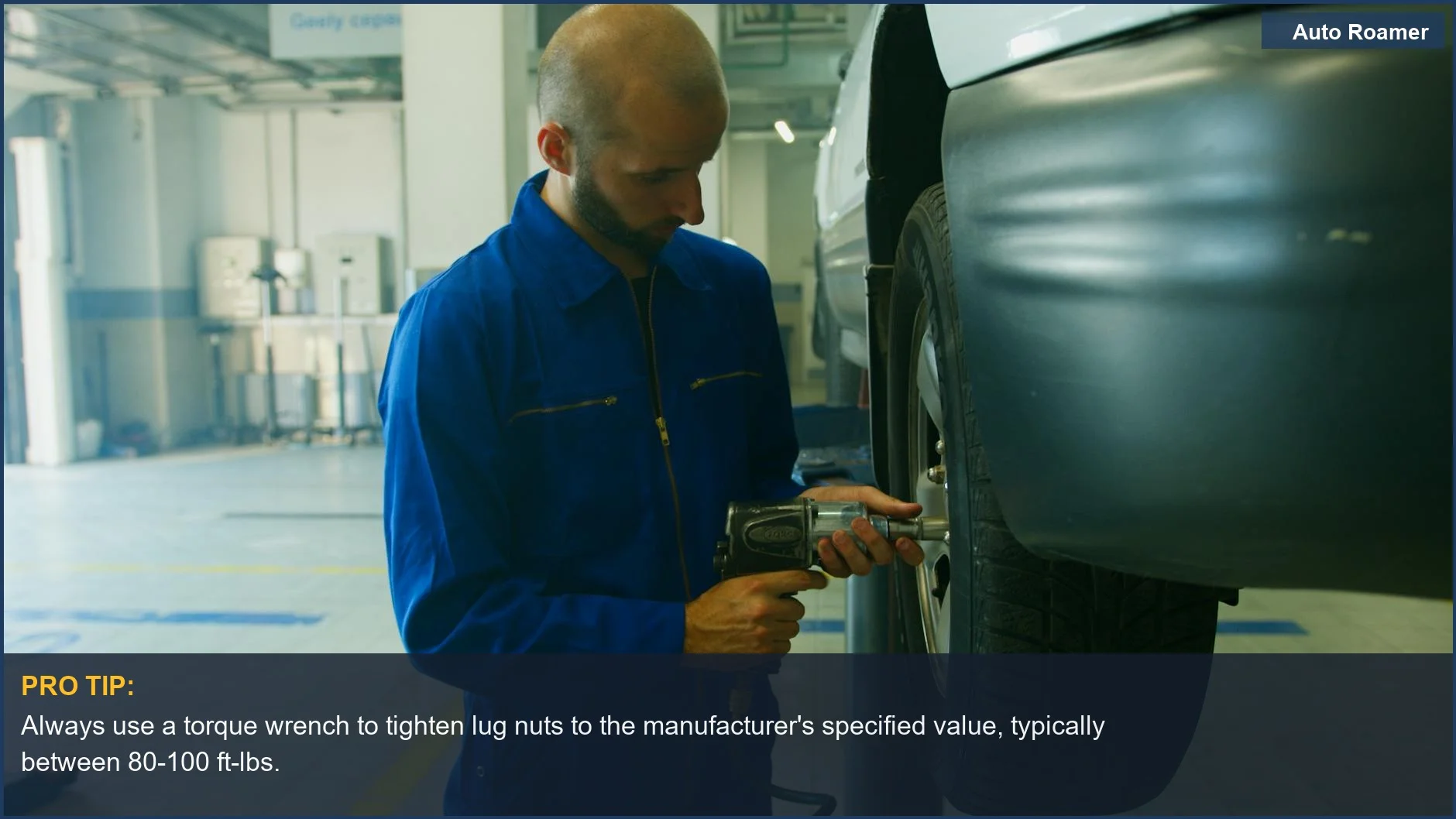 Mechanic uses an impact wrench to tighten lug nuts, demonstrating proper tire change torque for a secure wheel.