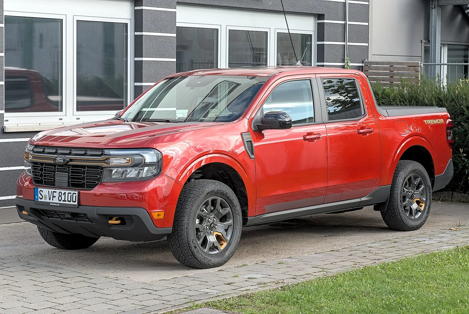 A red Ford Maverick compact pickup, the efficient do-it-for-less camper this comparison weighs against the Tacoma.