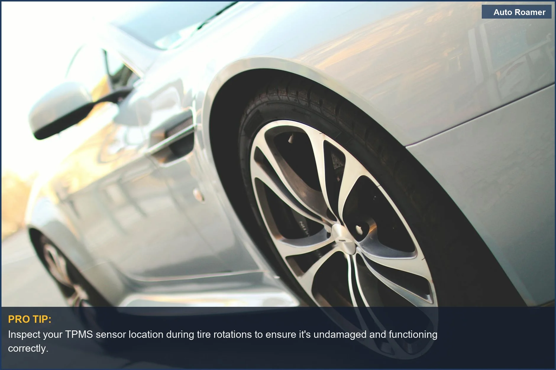 Close-up of a silver car wheel with a TPMS sensor visible inside, detailing tire pressure monitoring system components.