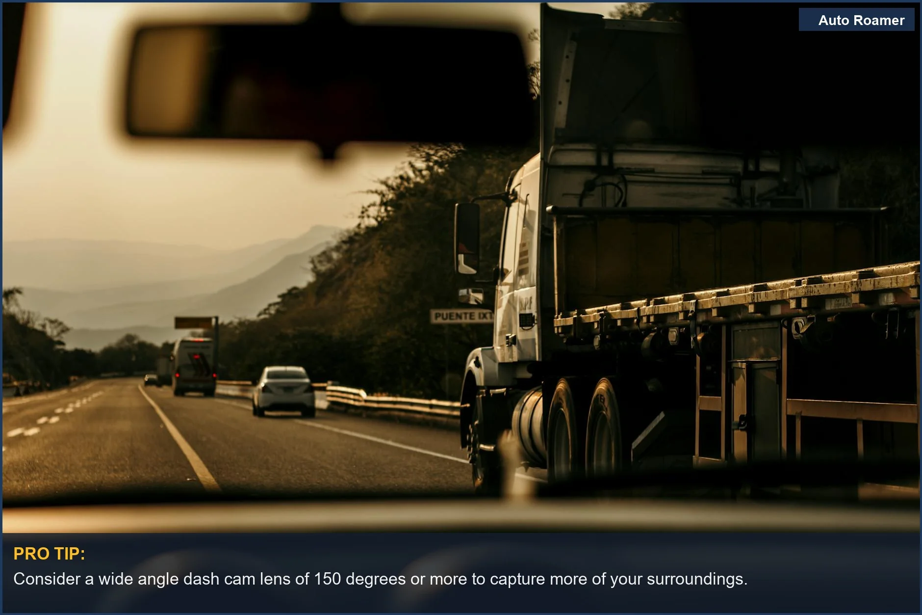 Cargo truck driving on a scenic highway at sunset, illustrating the need for a wide angle dash cam.