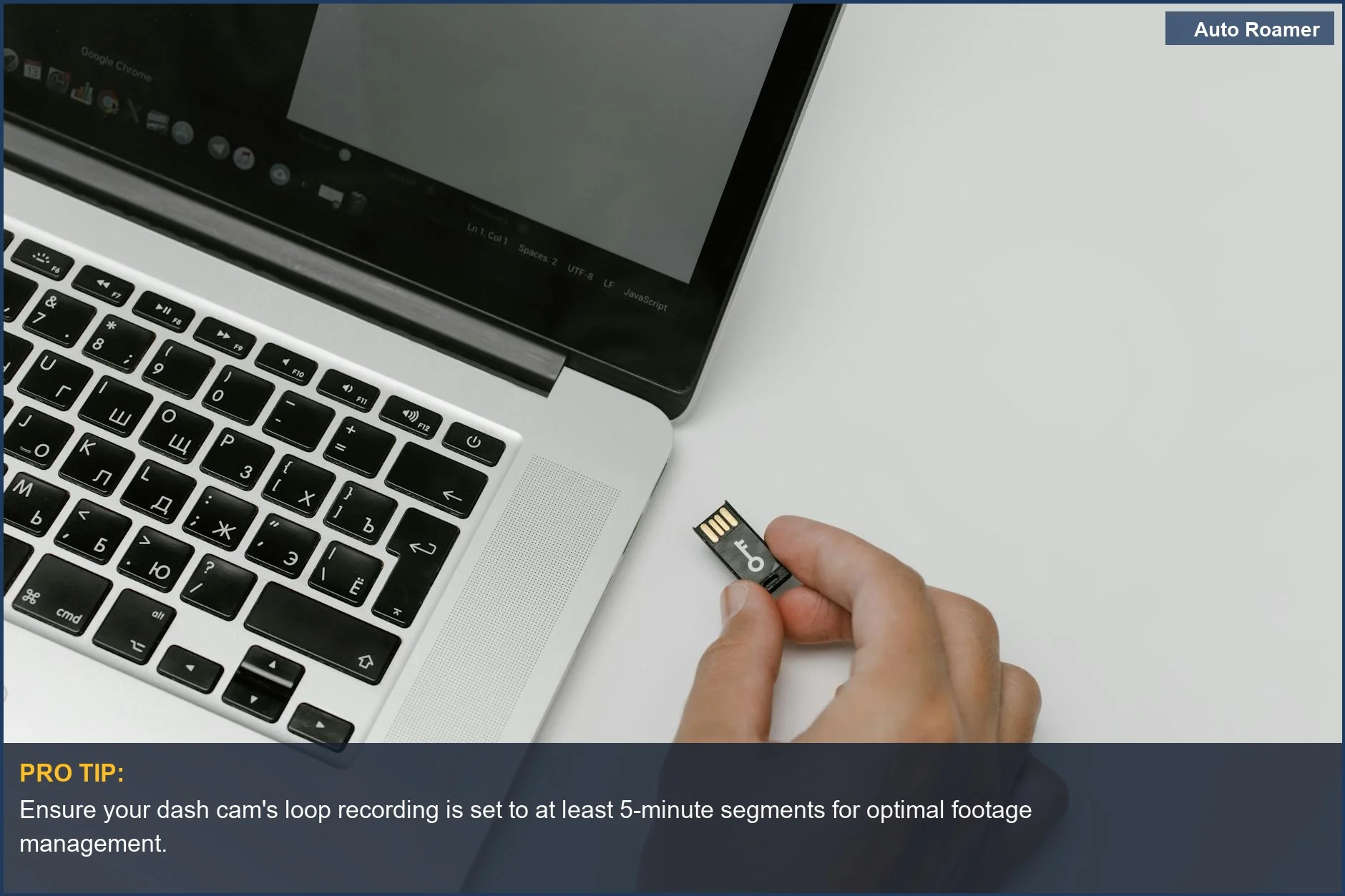Trucker's hand inserting a USB drive into a laptop, illustrating dash cam data transfer and loop recording.