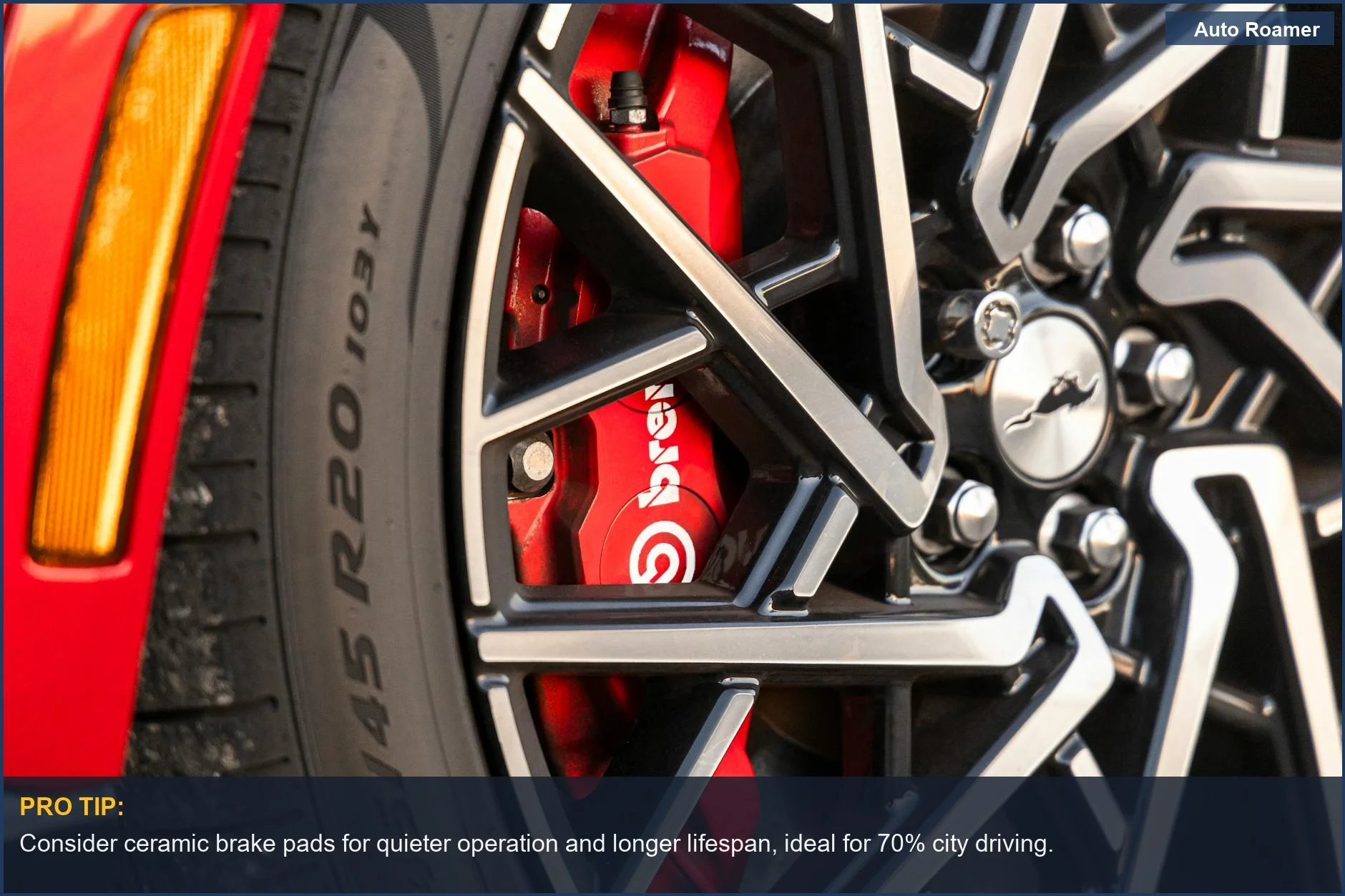 Detailed view of a red Brembo brake caliper and alloy wheel, showcasing advanced automotive technology.