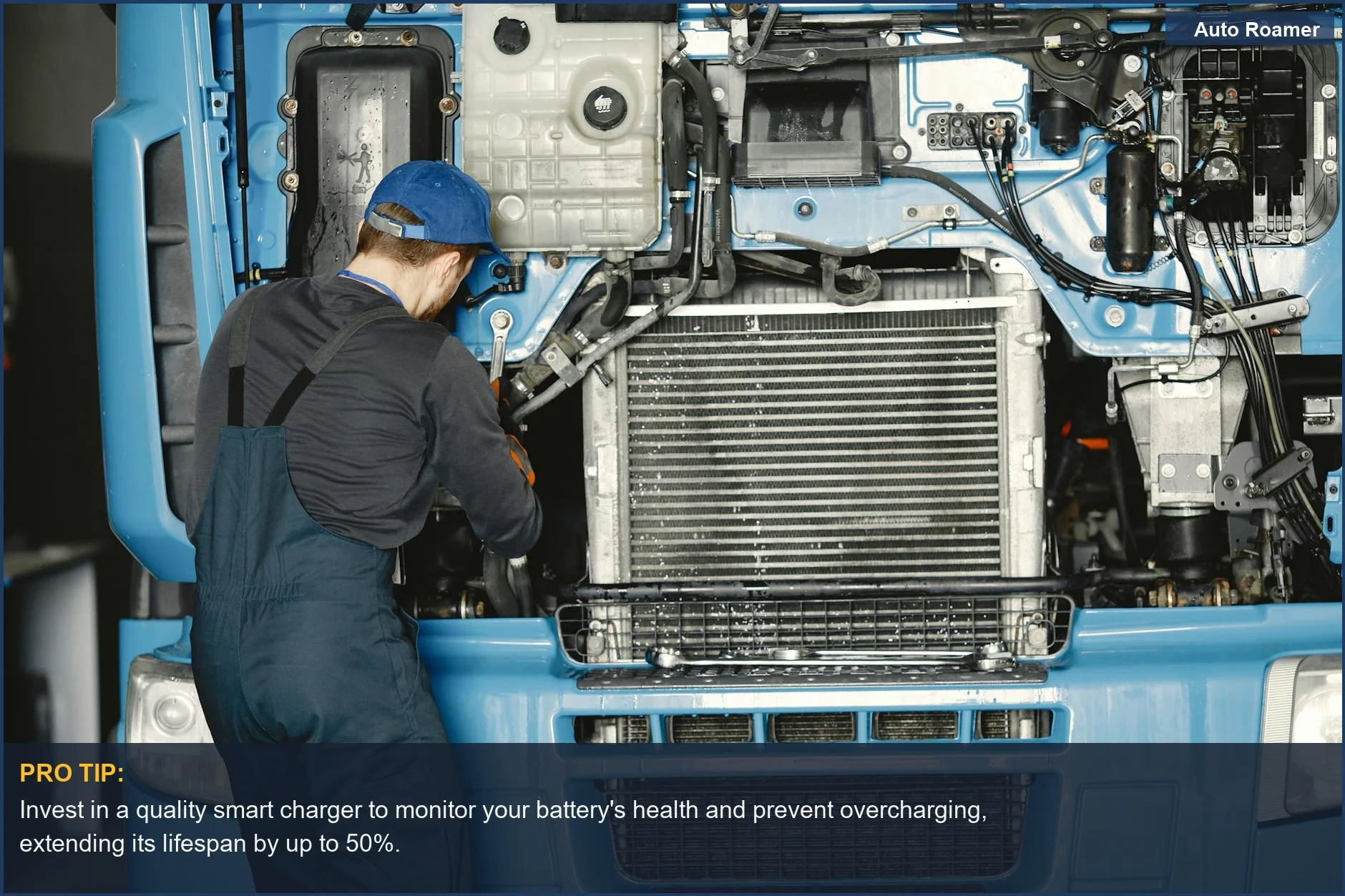 Skilled mechanic performing maintenance on a truck engine in a busy industrial workshop.