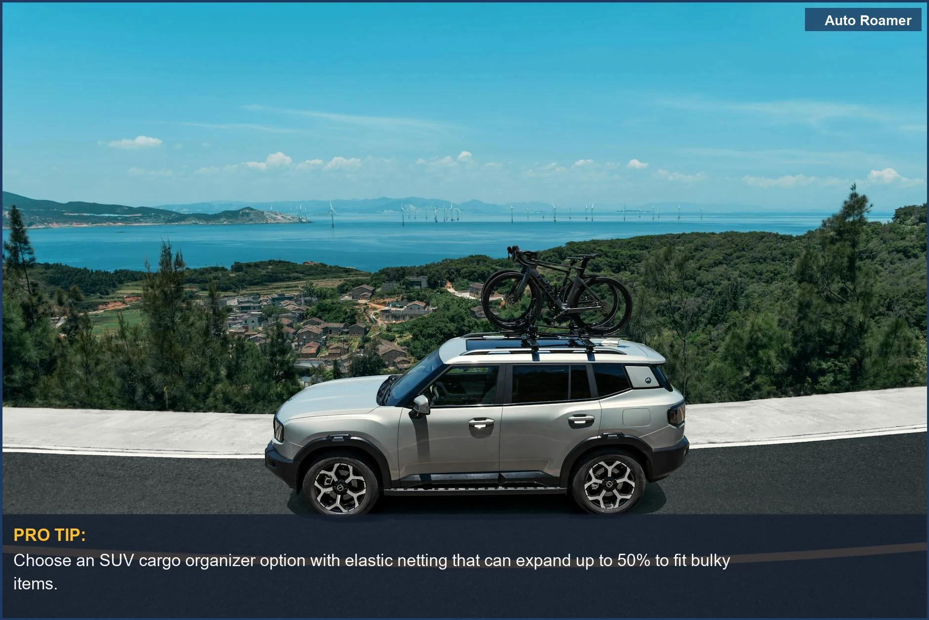 Silver SUV with bicycles on the roof rack, driving on a coastal road, emphasizing cargo carrying capacity.