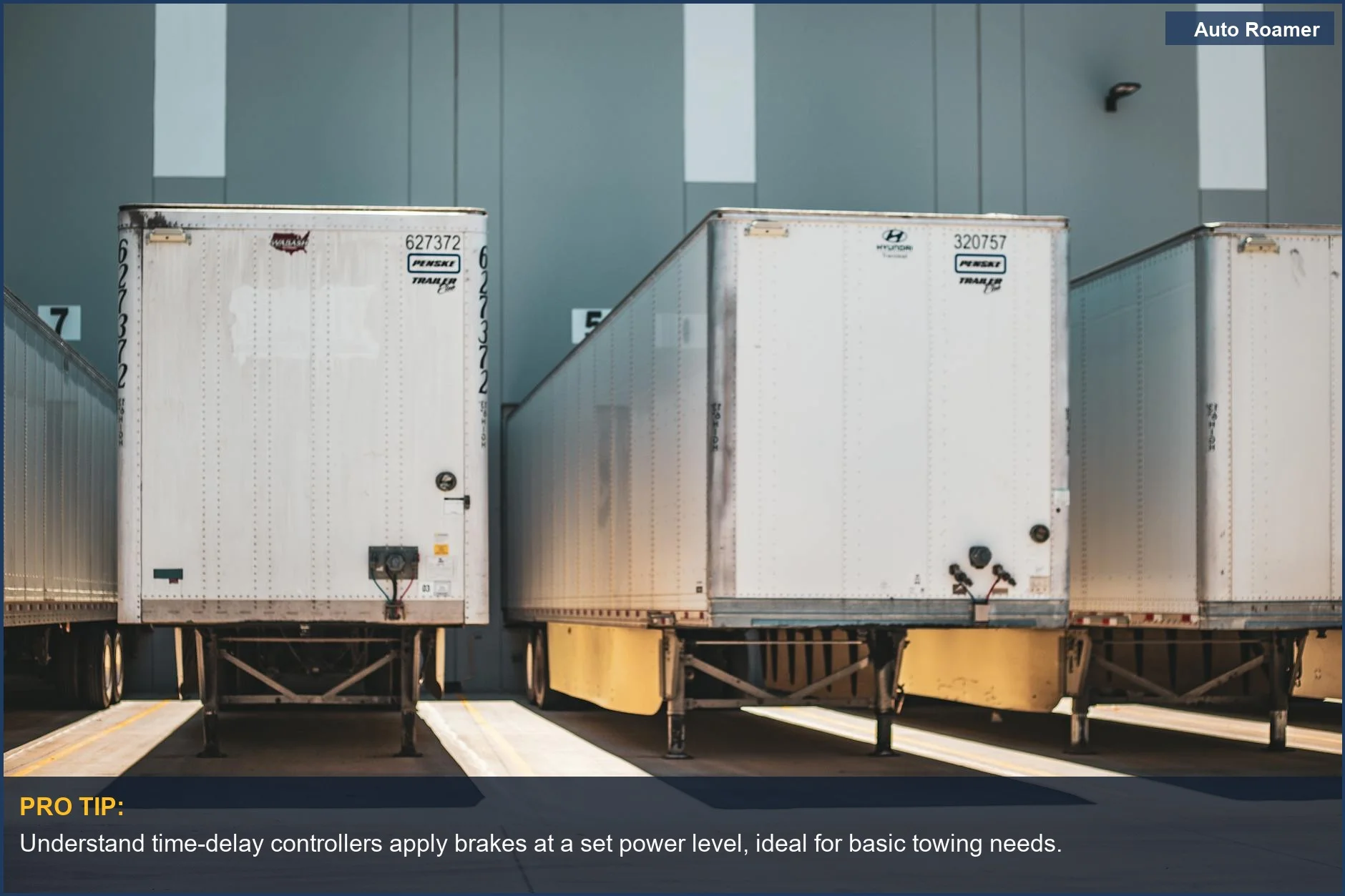 Freight trailers at loading dock, illustrating different trailer brake controller types for logistics.
