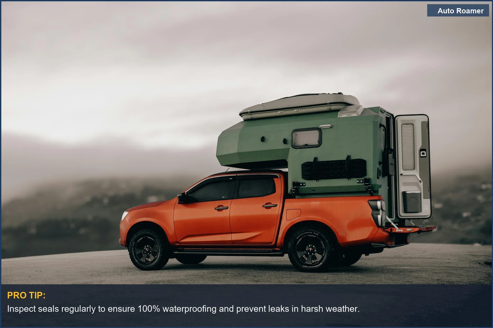 Vibrant orange pickup truck with a green camper shell on a foggy mountain road, perfect for truck bed cover camping.
