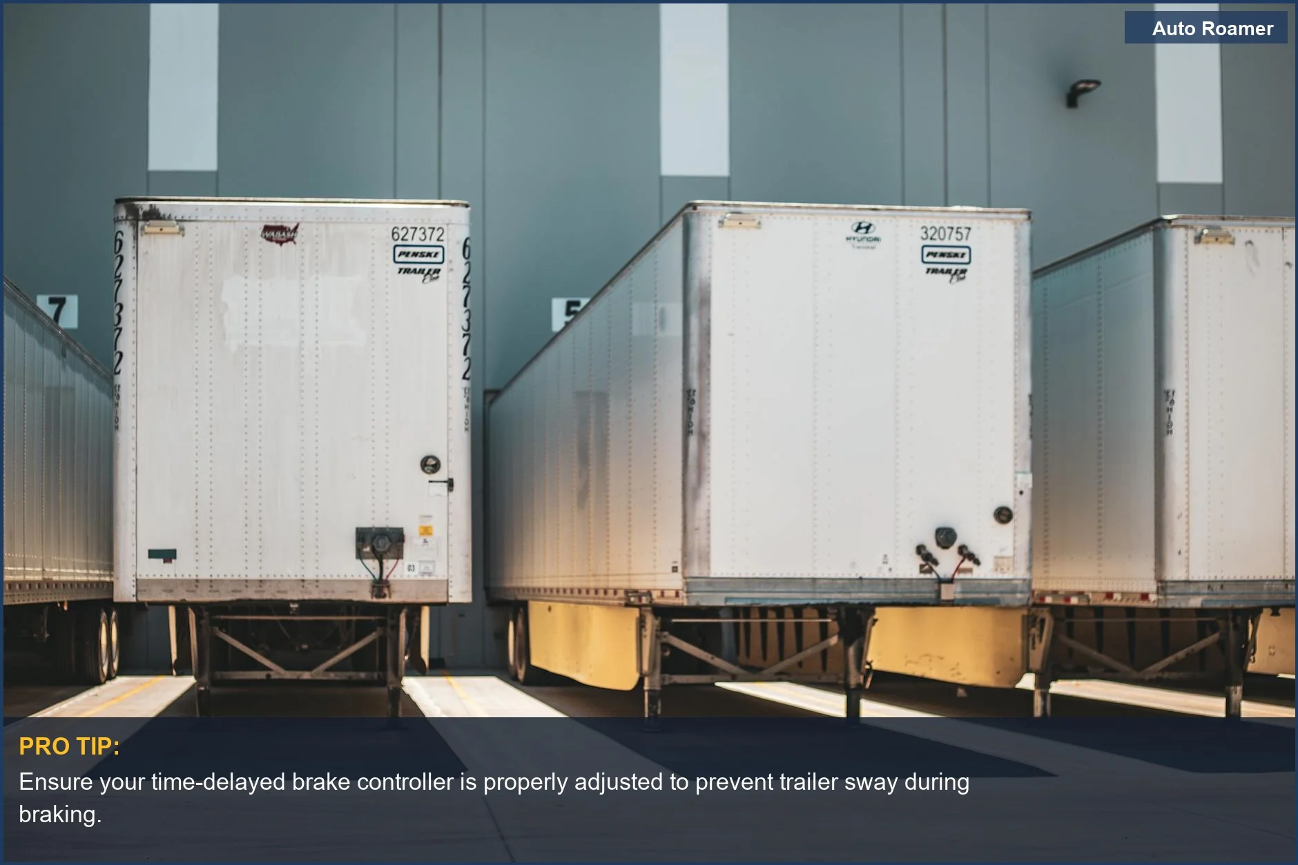 Commercial freight trailers lined up at a loading dock, illustrating logistics and towing needs for a time-delayed brake controller.