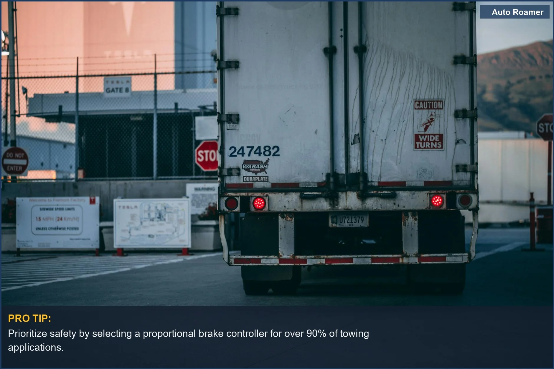 Semi truck parked at a loading dock with caution signs, emphasizing safety considerations for selecting brake controller types.