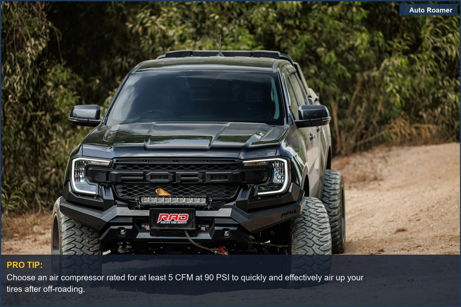 Black off-road truck navigates a lush, green, rugged dirt path, showcasing versatile off-roading scenarios and equipment needs.