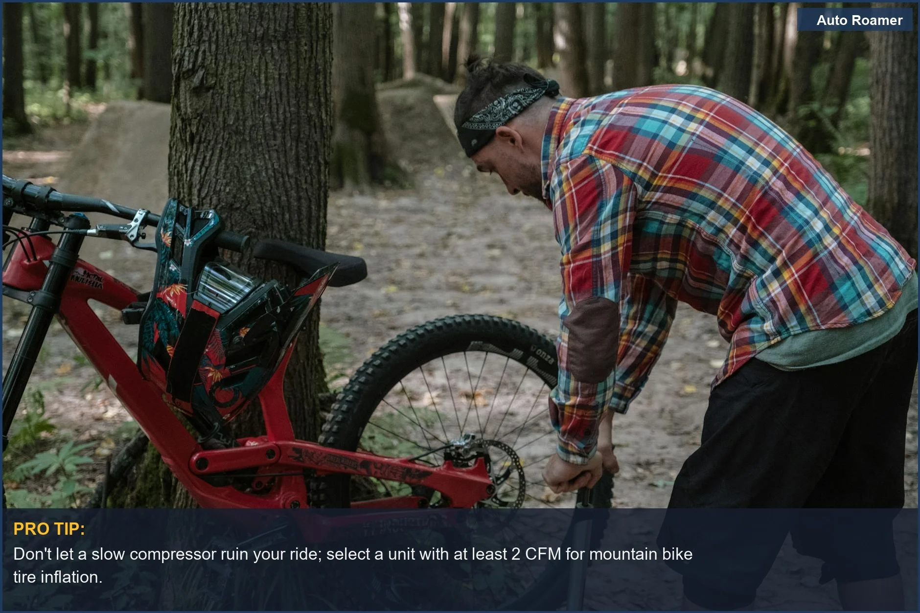 Man pumps mountain bike tire in nature, showcasing the need for adequate compressor CFM for outdoor adventures.