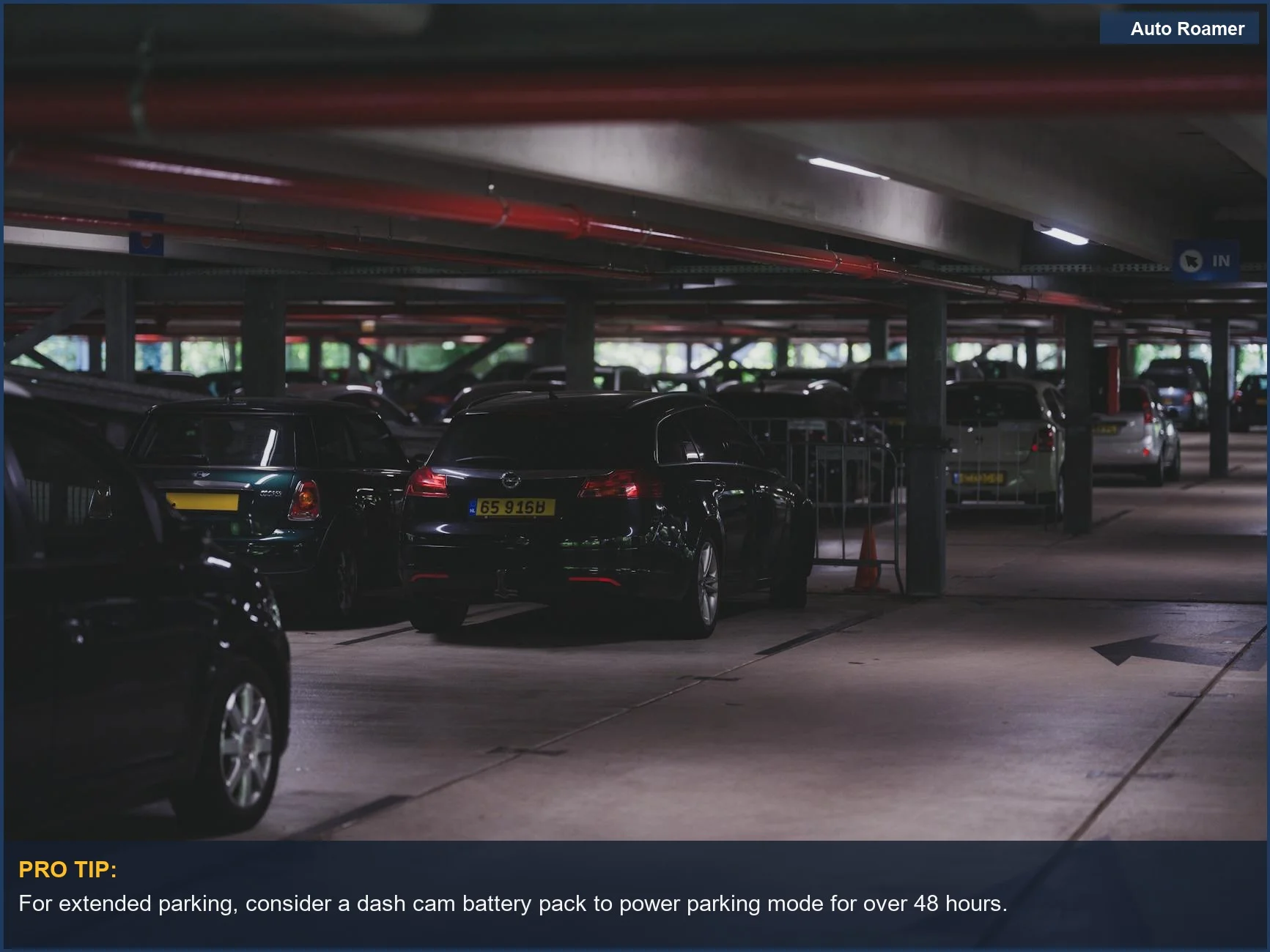 Dimly lit underground parking garage with parked cars and entrance signs, showcasing parking mode needs.