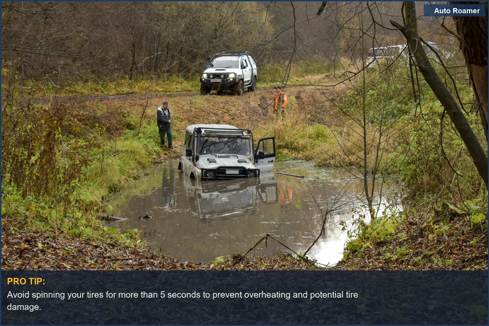 SUV vehicle recovery from muddy water on a forest trail using recovery tracks.