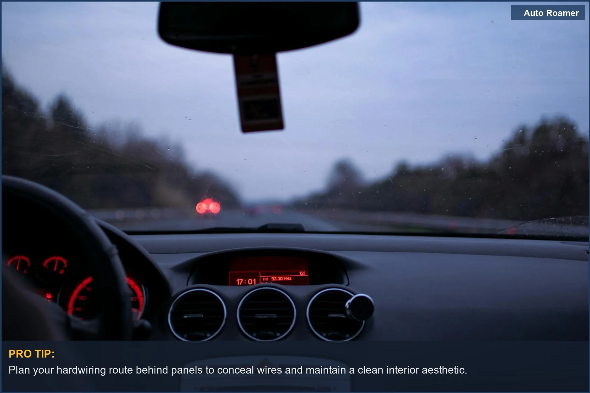 Highway driving at twilight, showing a car's illuminated dashboard and windshield, perfect for hardwiring dash cam considerations.
