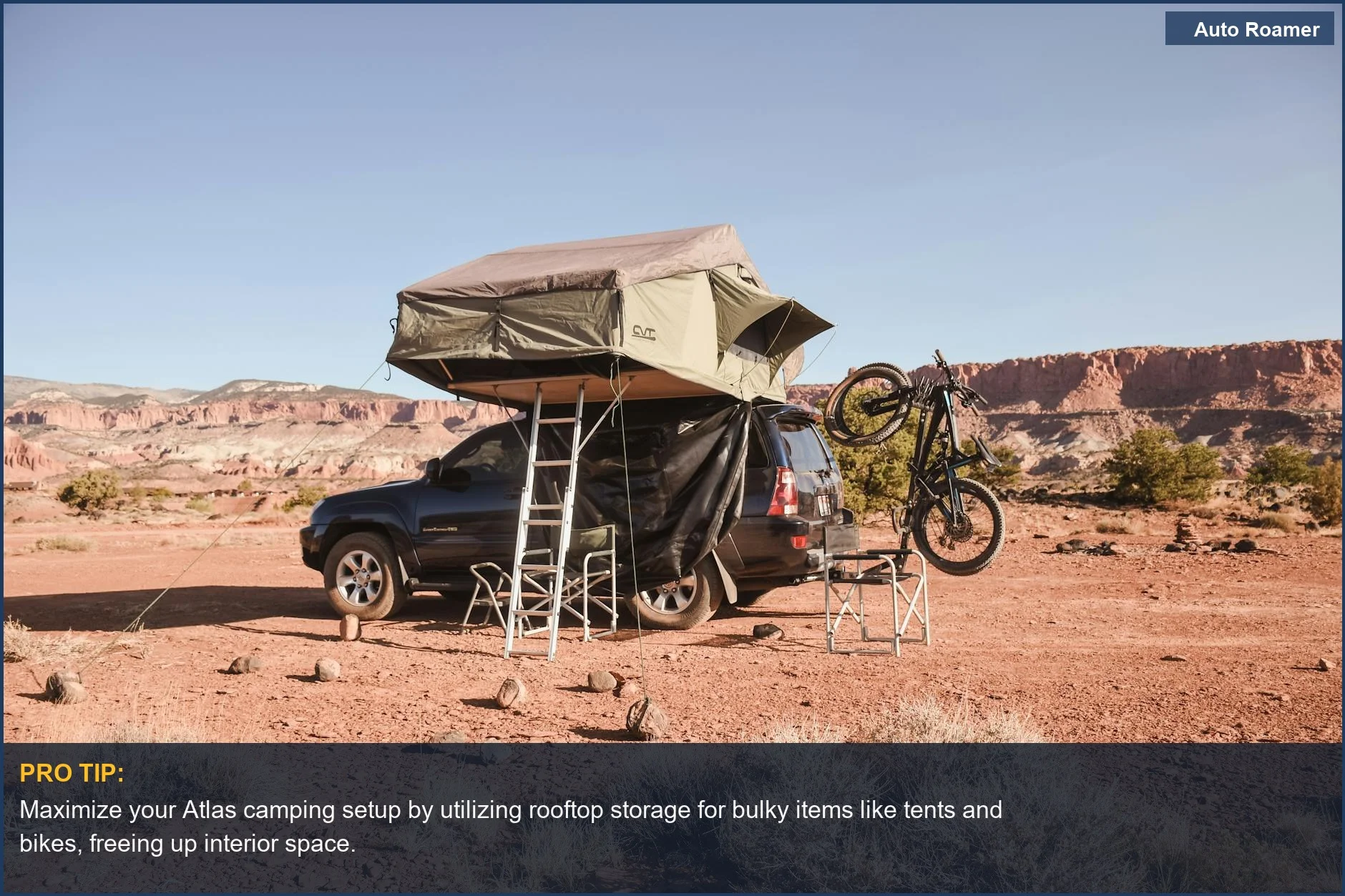 Volkswagen Atlas camping setup with rooftop tent and mountain bike in a desert landscape.